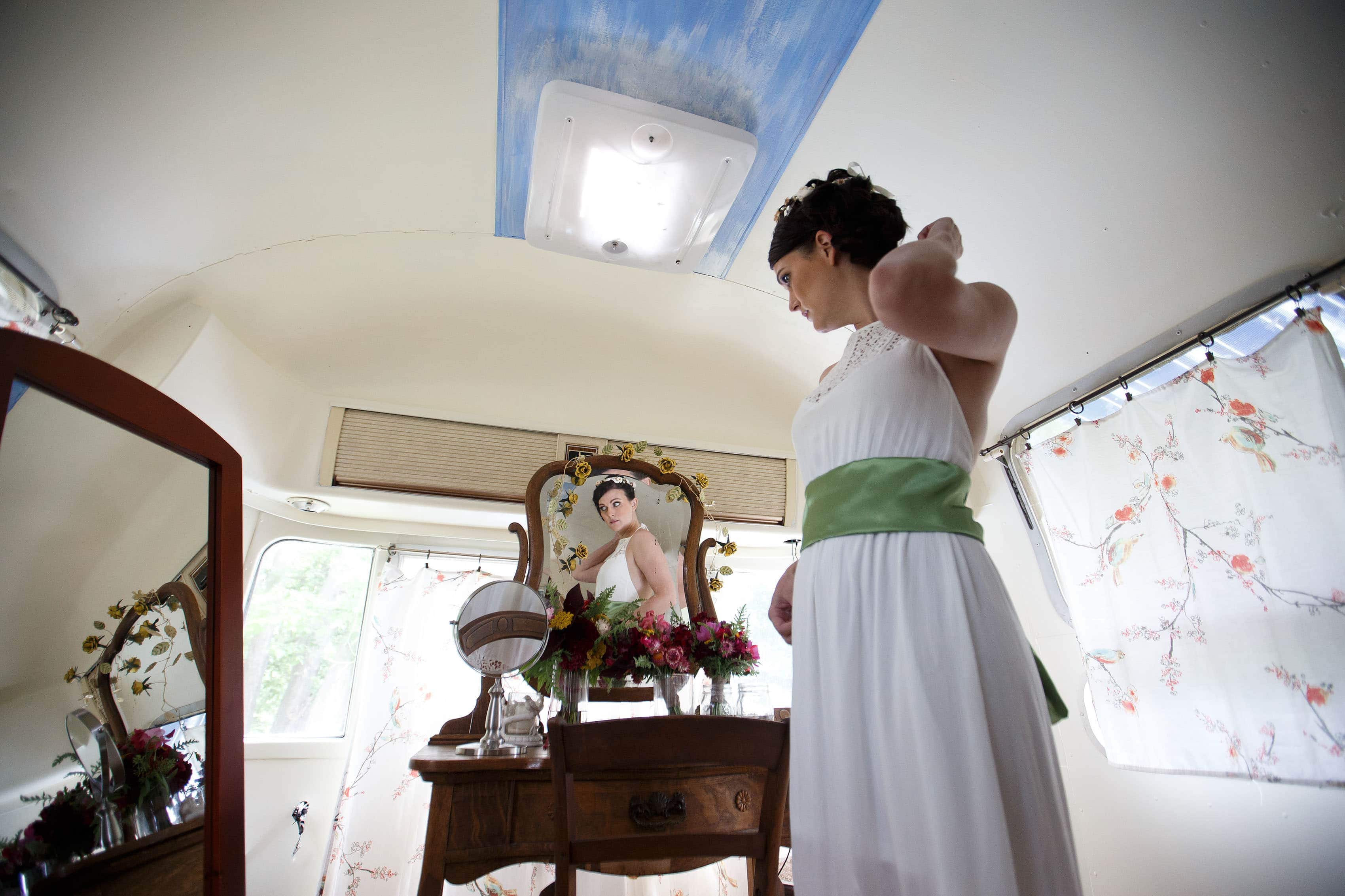 Meghan looks in the mirror inside the airstream at Lyons Farmette