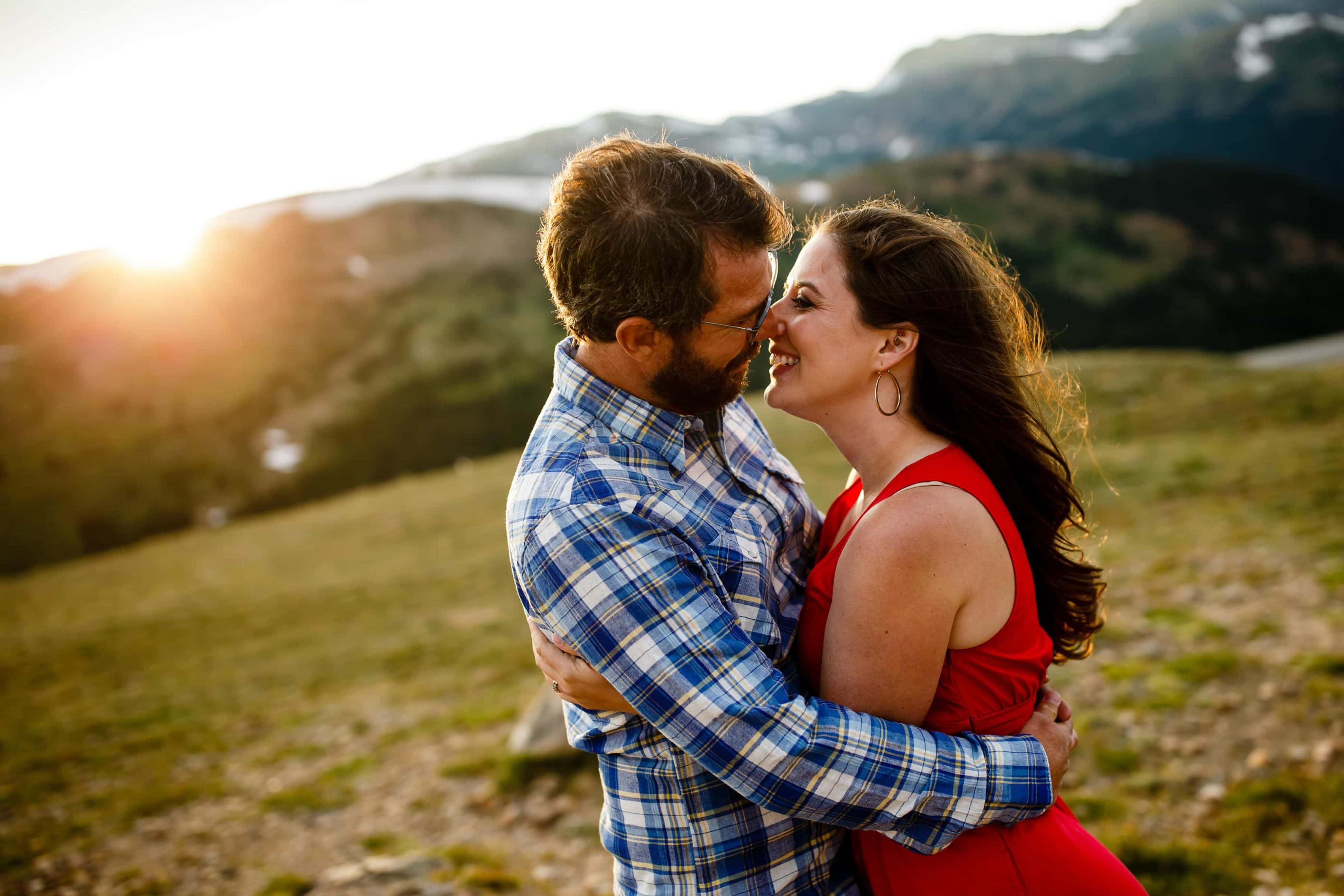 The sun sets behind Mallory and Daniel atop Loveland Pass in Colorado during their July engagment session