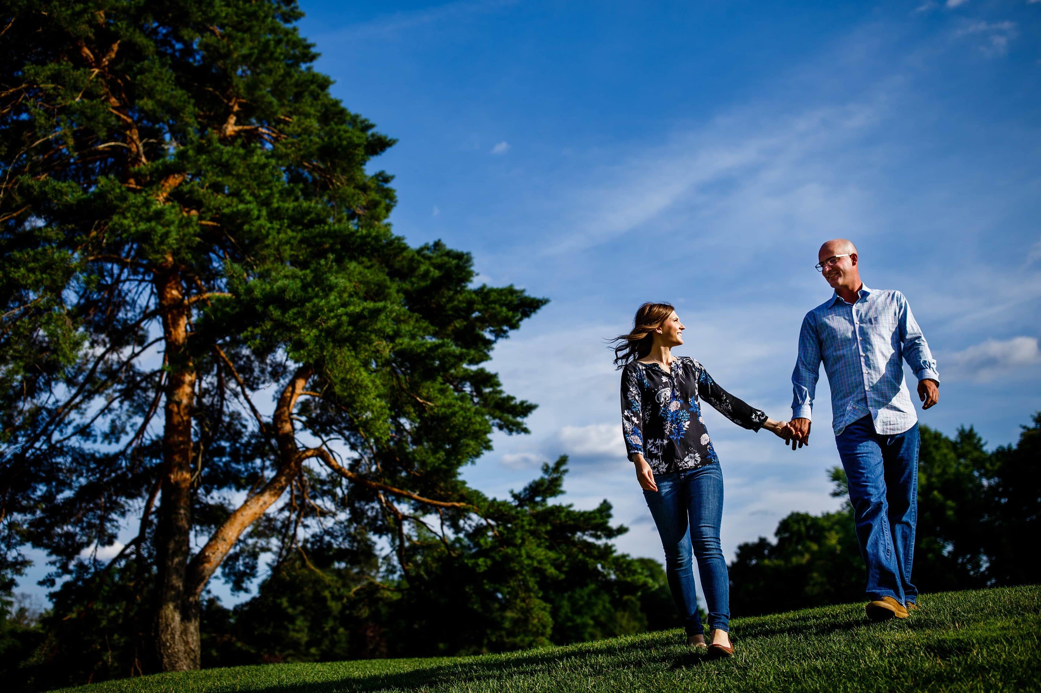 Erica and Cody walk together at Red Run Golf Club in Royal Oak, Michigan during their summertime engagment session