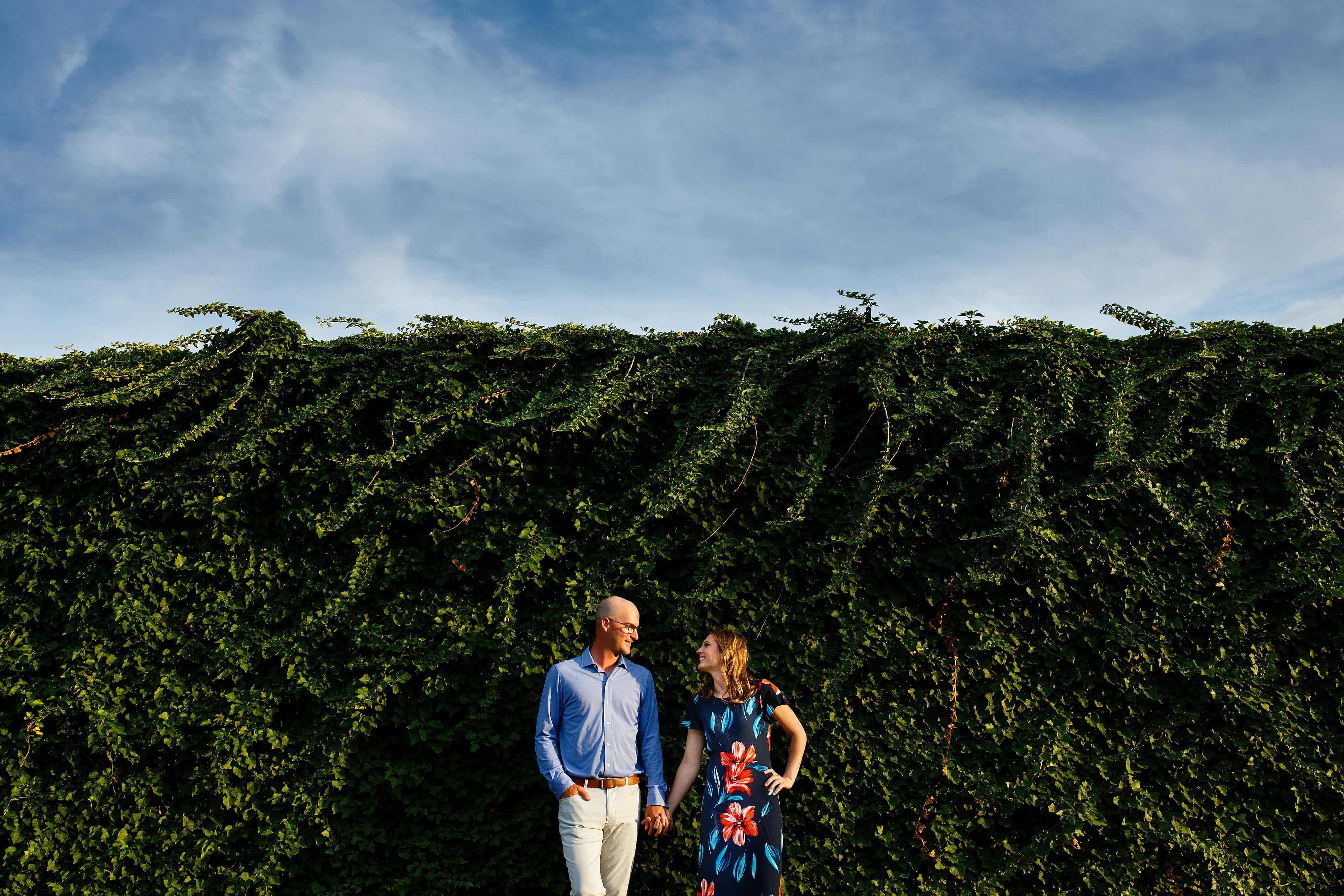 Cody and Erica pose during their summer engagement photos in downtown Royal Oak, Michigan