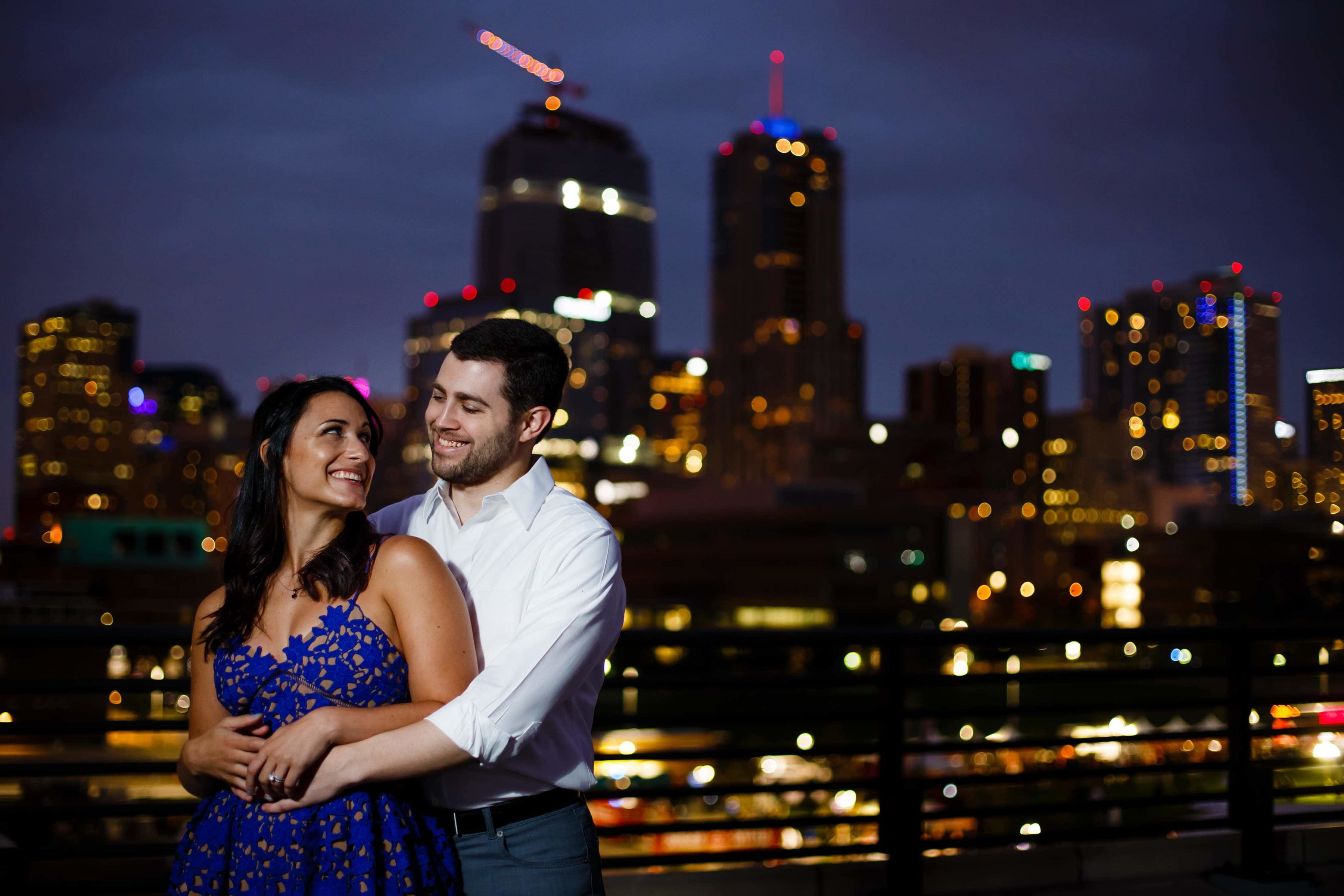 Danielle and Jordan pose together with the Denver skyline in the background during their engagement session