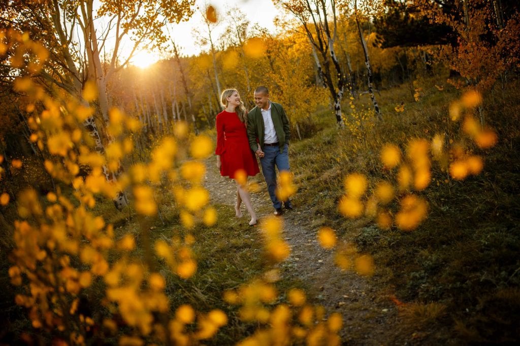 Paige and Adam walk along Mule Deer Trail during their Golden Gate Canyon State Park engagement