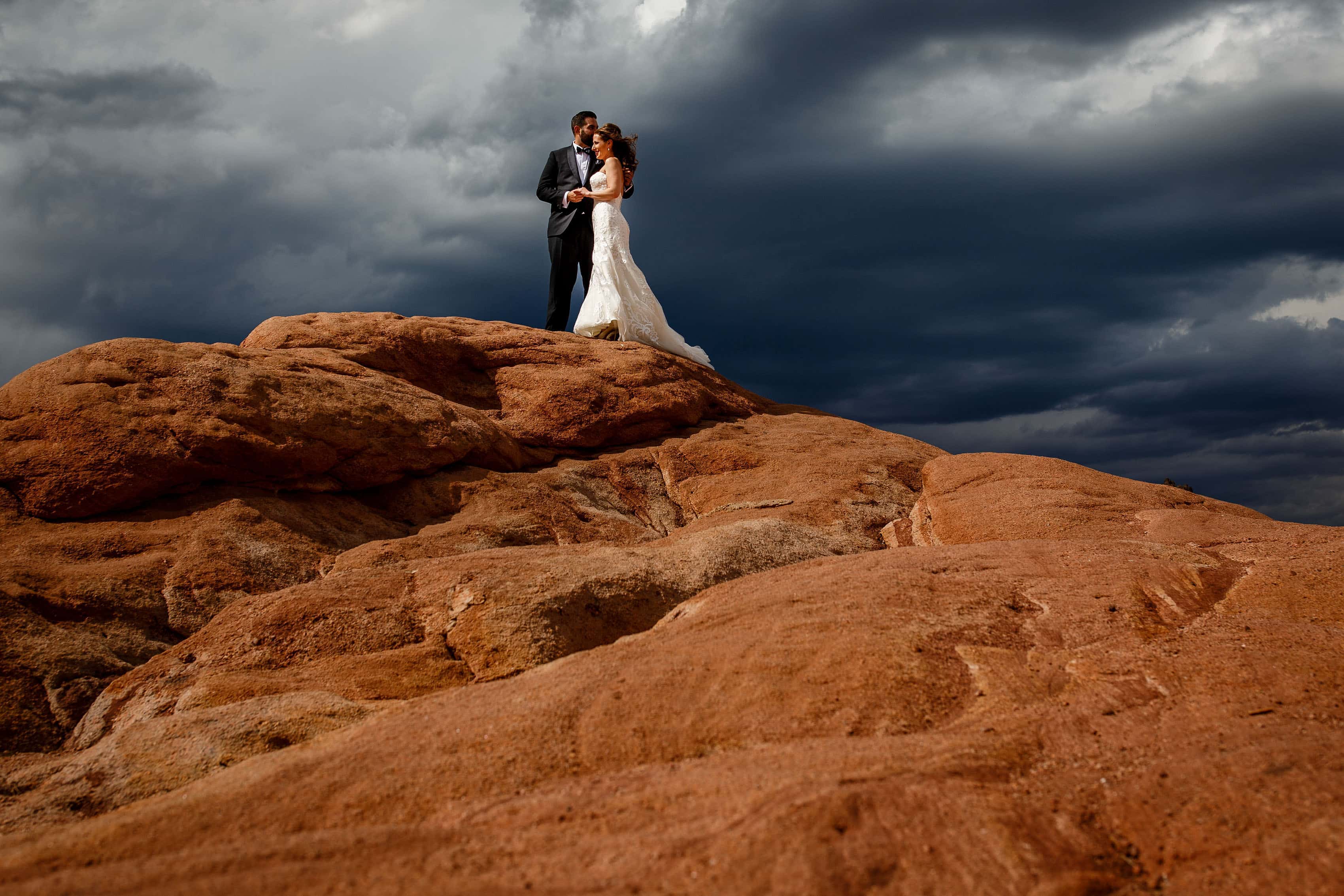 The couple share a moment on the red rocks for a portrait at Garden of the Gods park in Colorado Springs