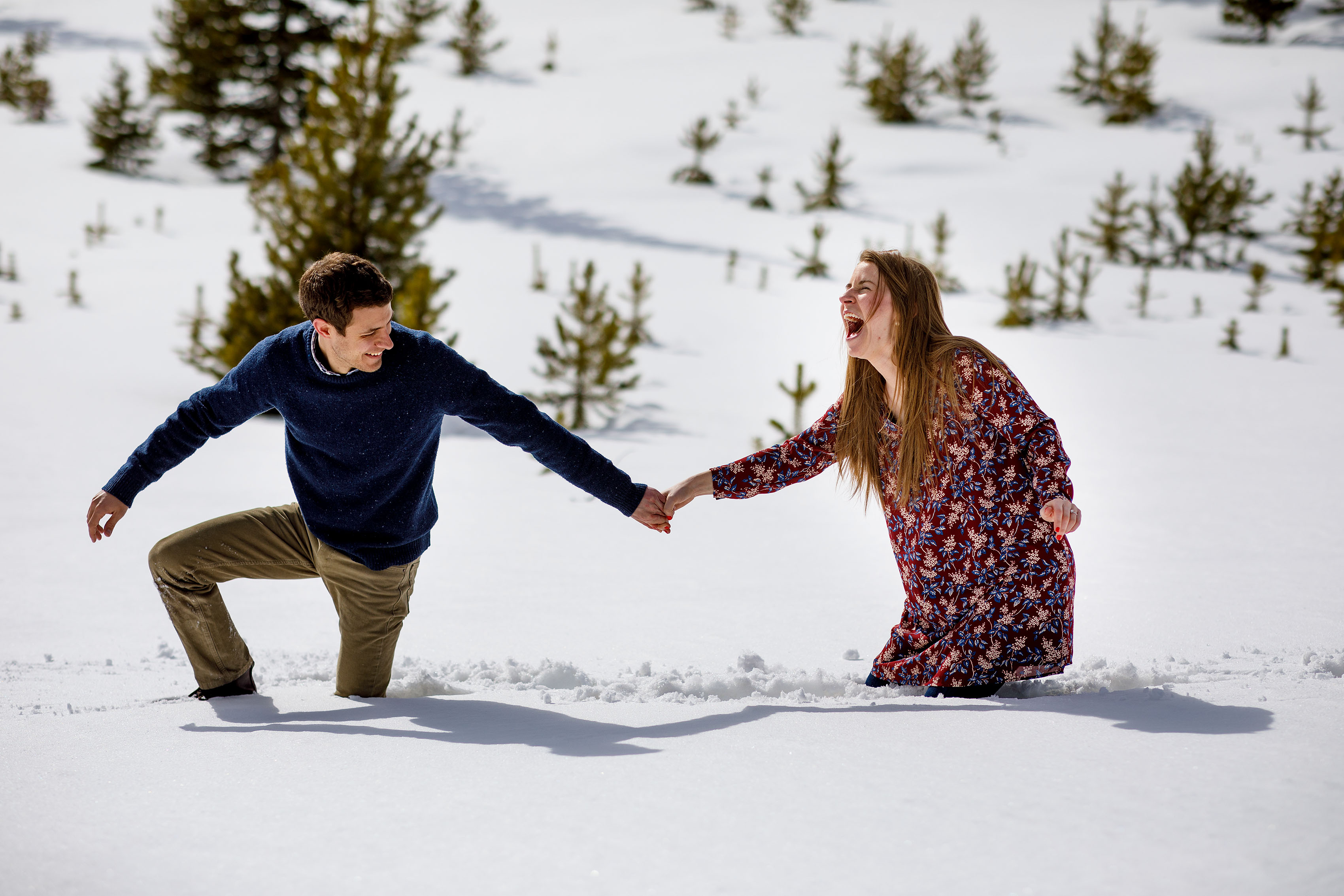 Jessica reacts after falling in the snow with Mike during their engagement session in Dillon