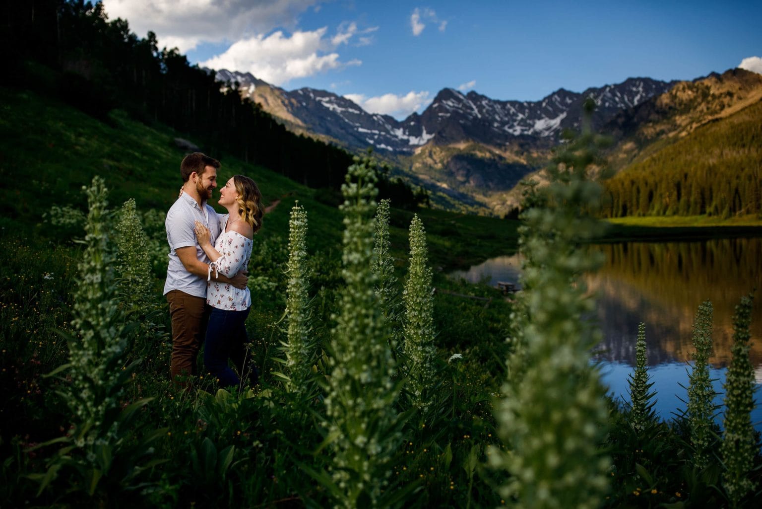 Ryan and Laura embrace during their engagement session at Piney Lake near Vail, Colorado