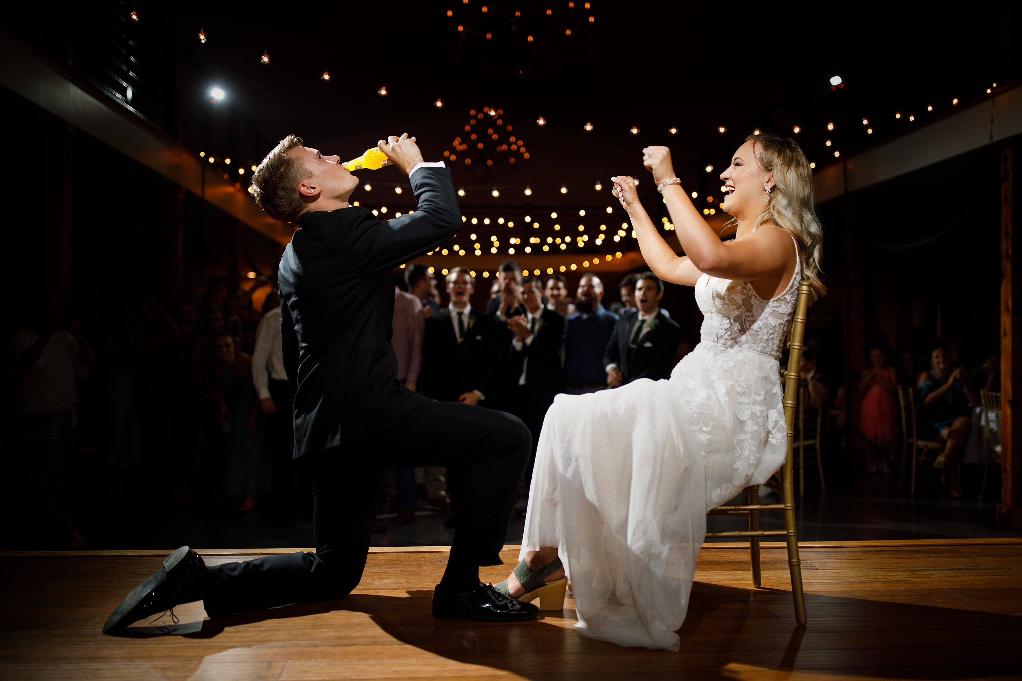 The groom gets iced by the bride during their wedding