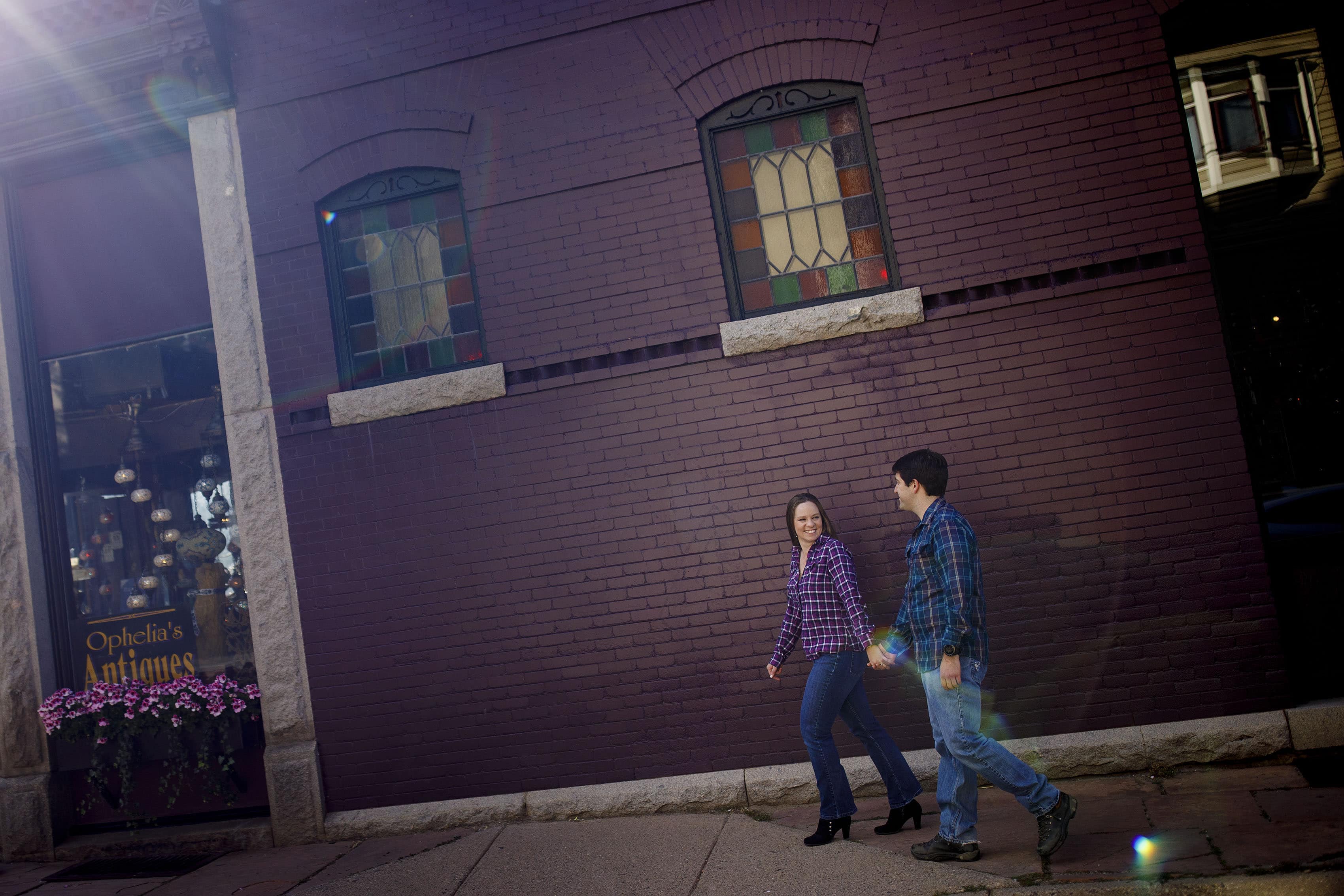 A couple walks by Ophelia's Antiques in Georgetown, Colorado during their engagement photos