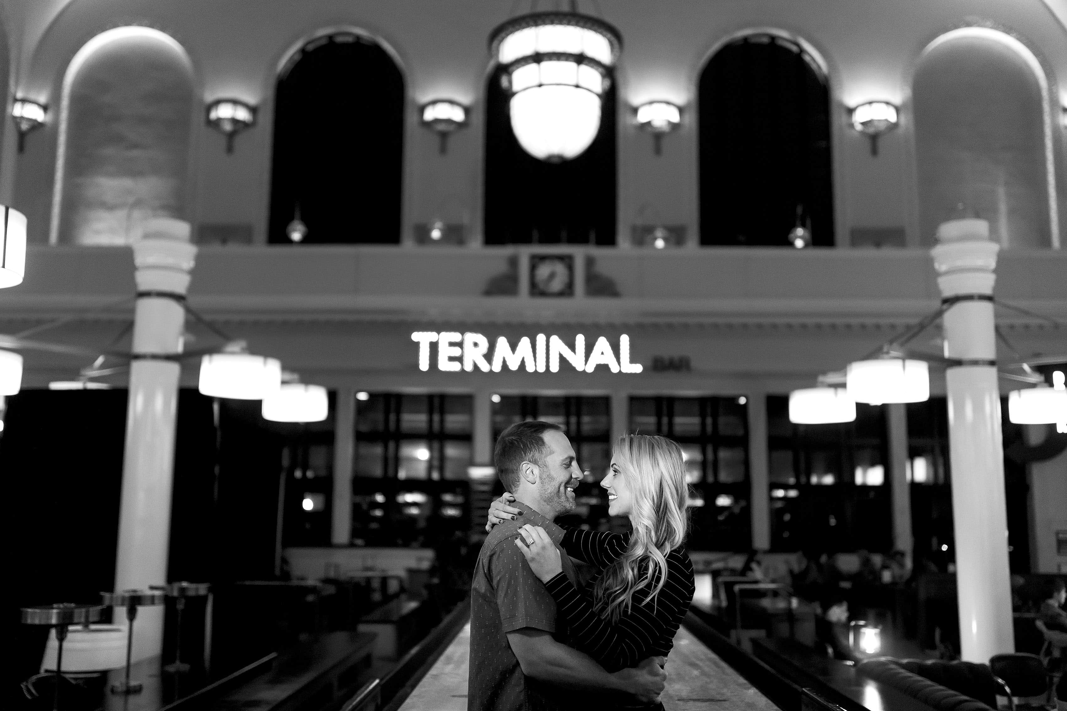 Mesha and Joe share a moment inside Denver's Union Station at the Terminal Bar during their engagement photos