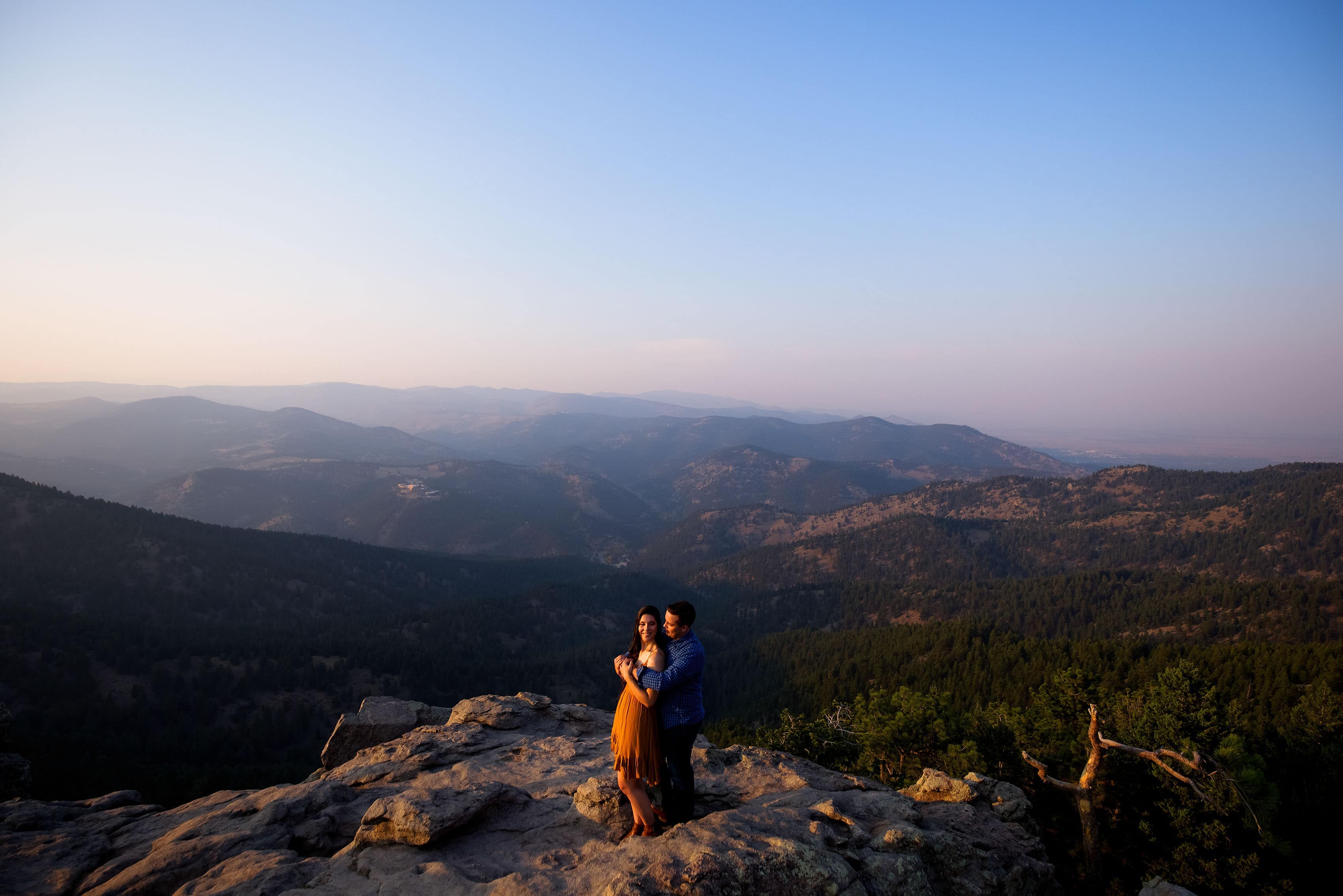 Briana and Tim embrace atop Lost Gulch Lookout during their engagement photos in Boulder
