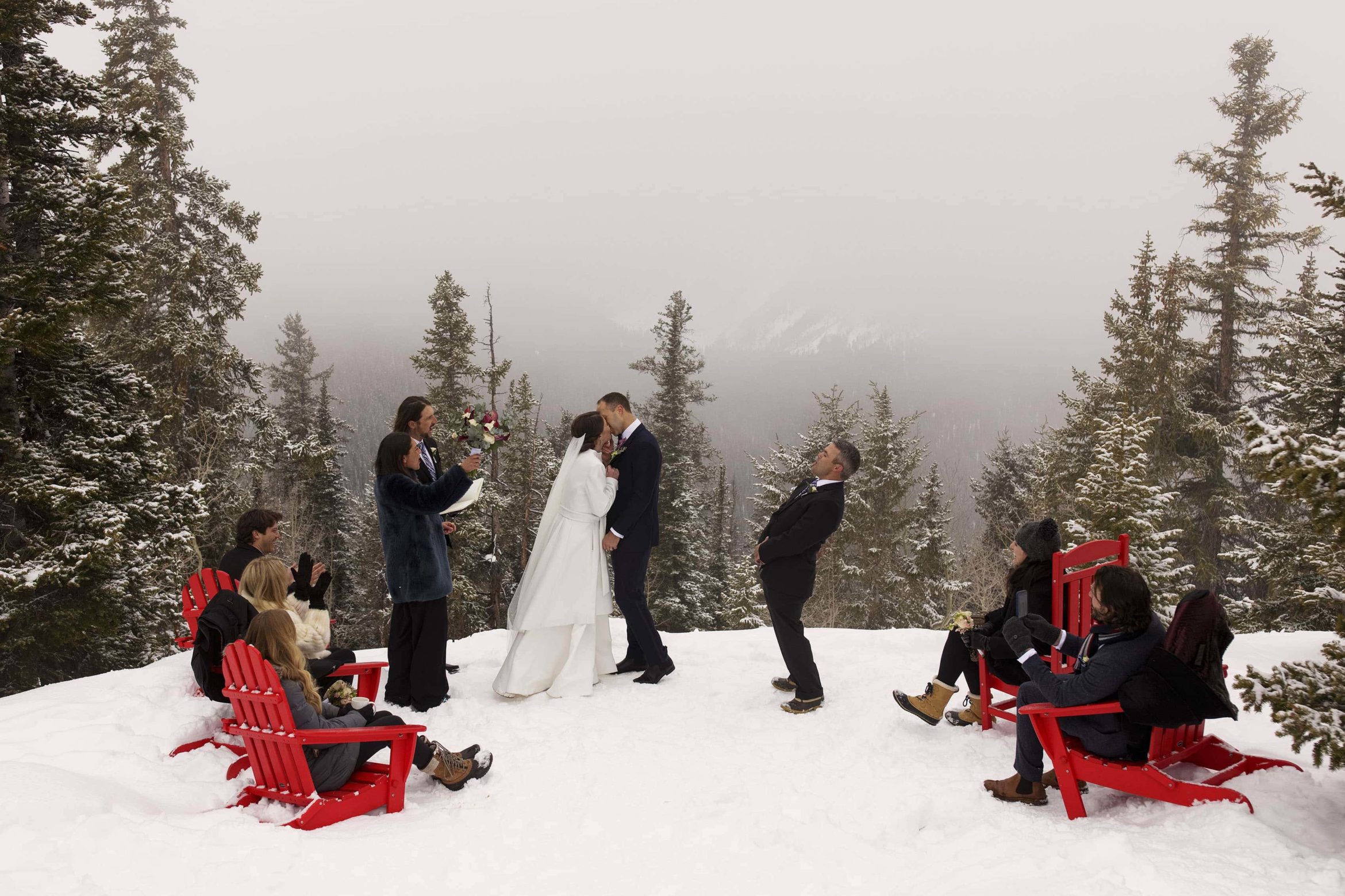 Olivia and Kyle’s first kiss on the snowy Aspen wedding deck