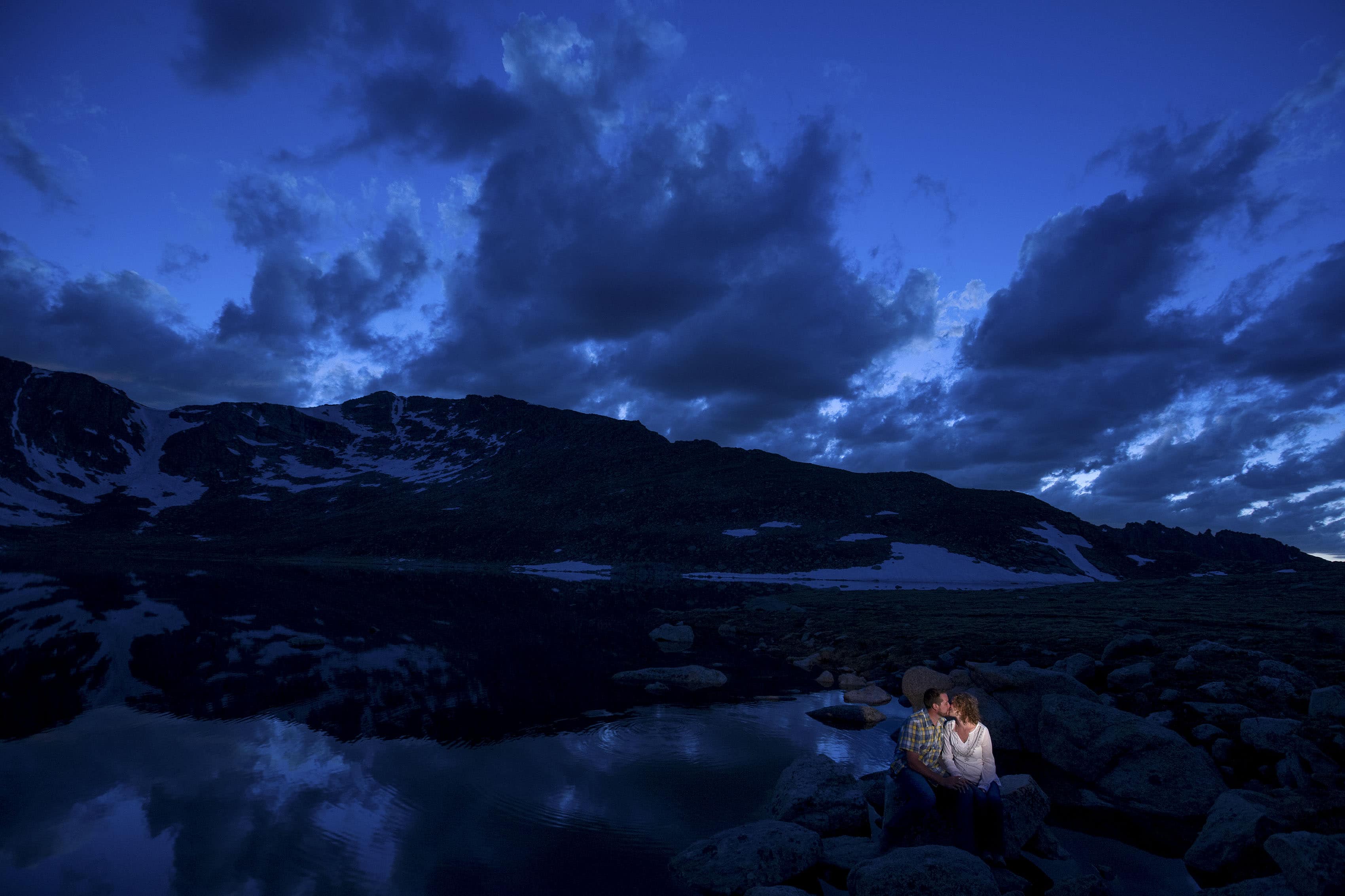 Matt and Jenny share a kiss at Summit Lake on Mount Evans during their engagement photos