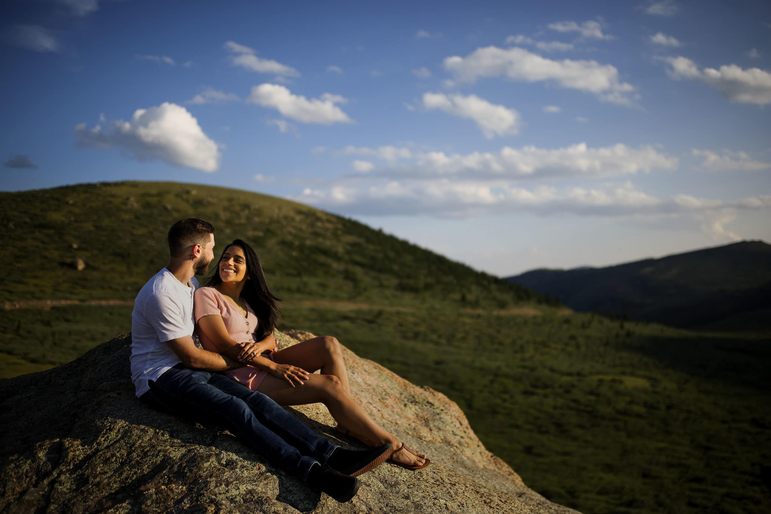 A couple sit on a rock atop Guanella Pass