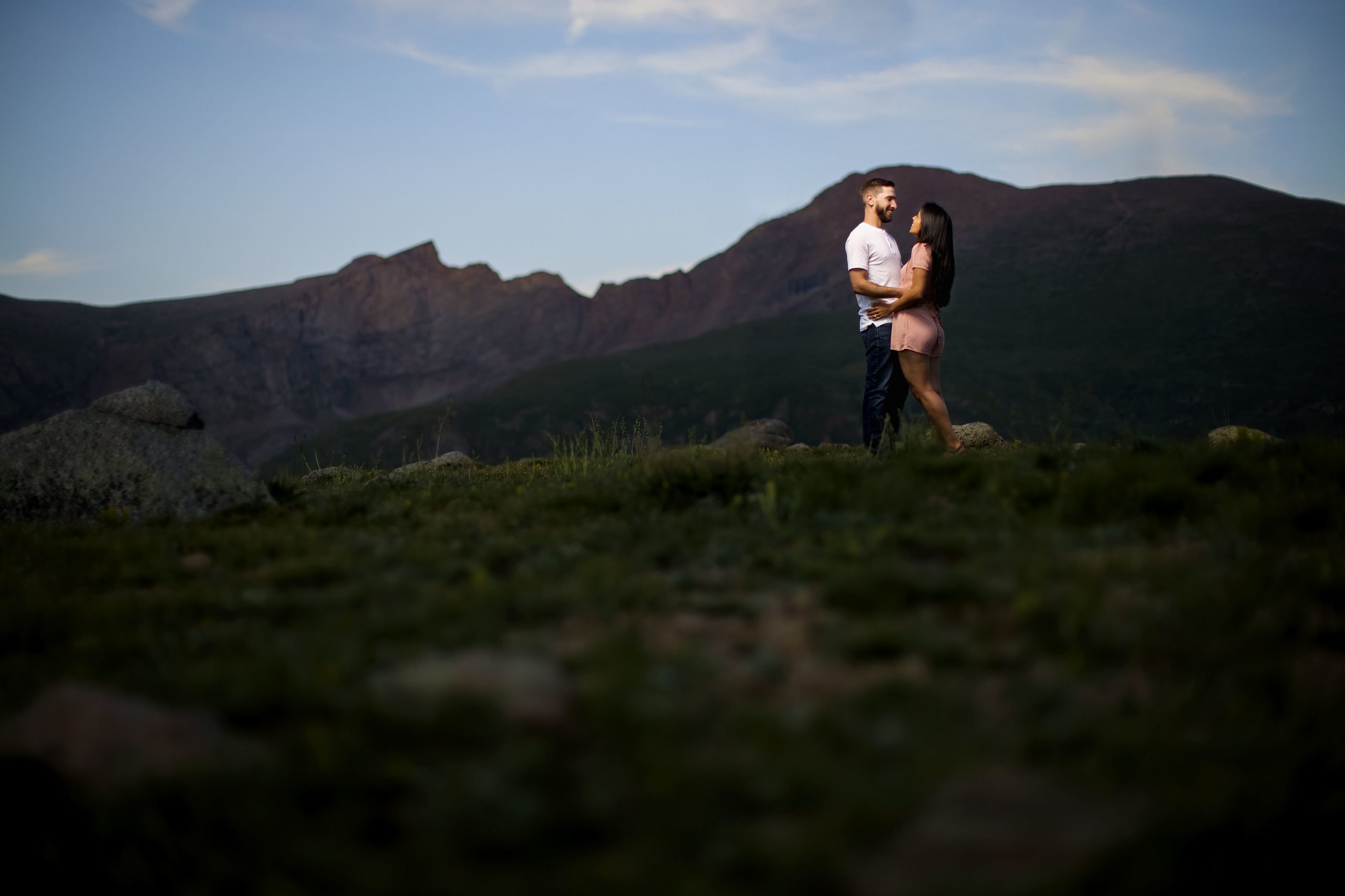 A couple pose following their surprise proposal in Guanella Pass at twilight