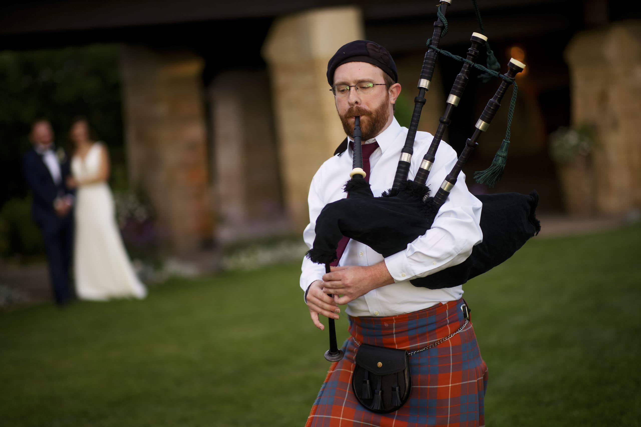 A bagpiper plays during Casey and DarrenÕs wedding reception at Sanctuary Golf Course