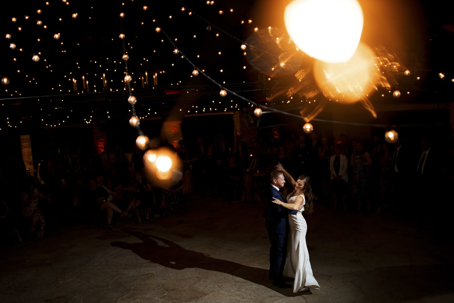 Darren and Casey share their first dance as newlyweds under the market lights in the Sanctuary pavillion