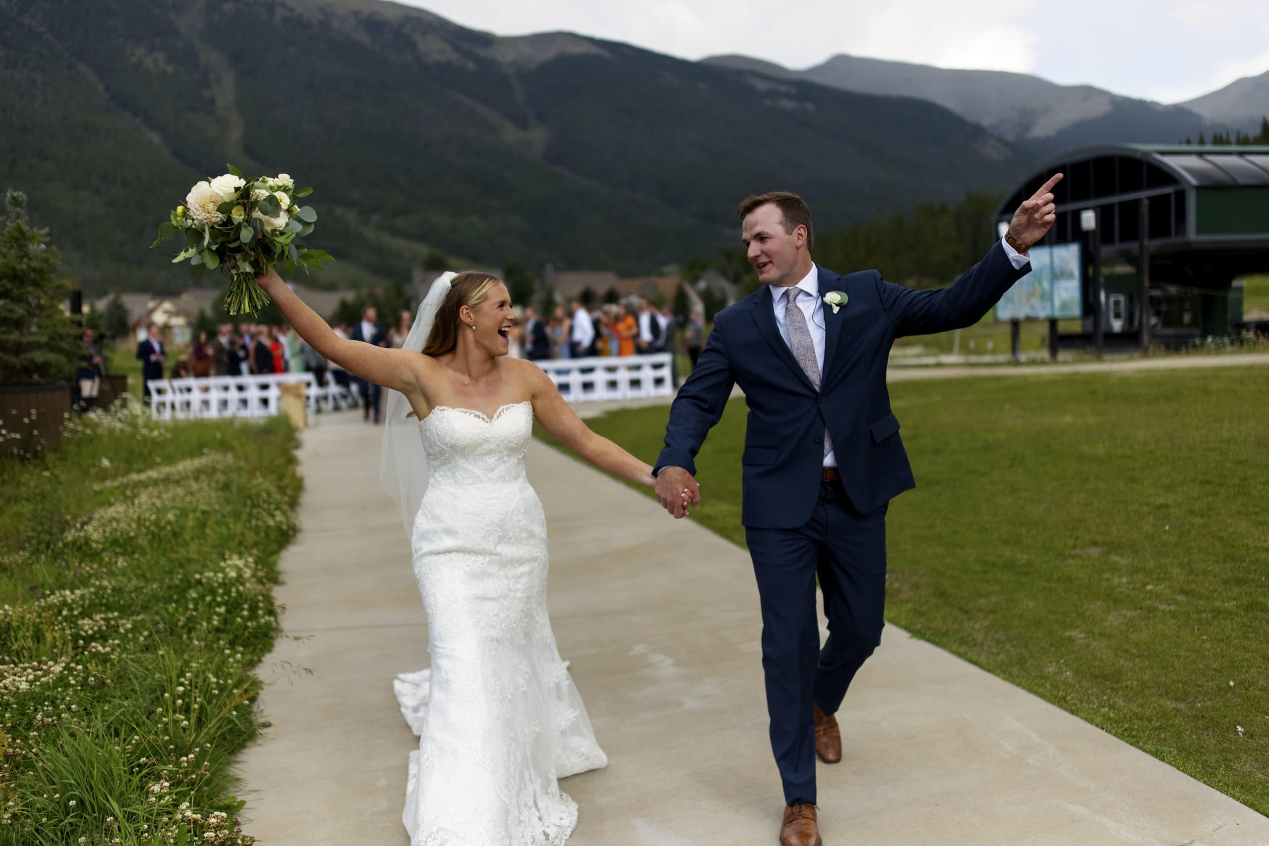The bride and groom celebrate as they walk down the aisle together after their wedding ceremony at Copper Mountain’s Copper Vista