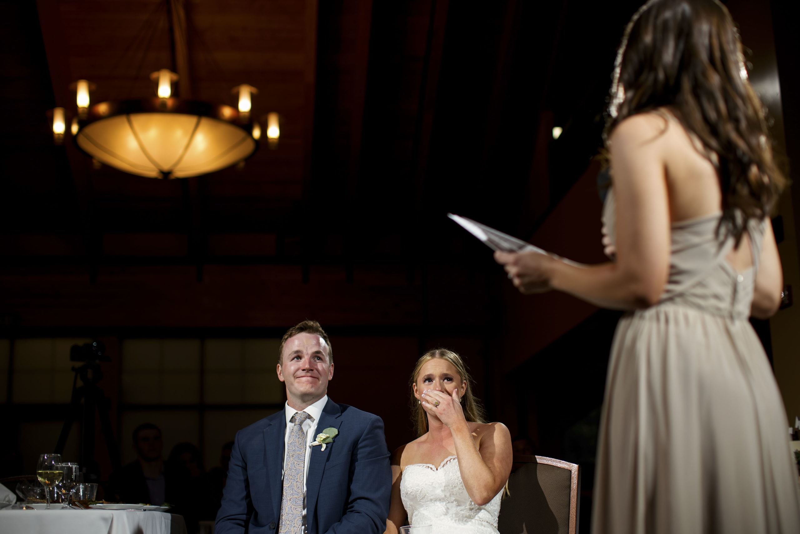 The maid of honor gives a toast as the bride and groom react during a wedding reception in the Grand Hall at Copper Station