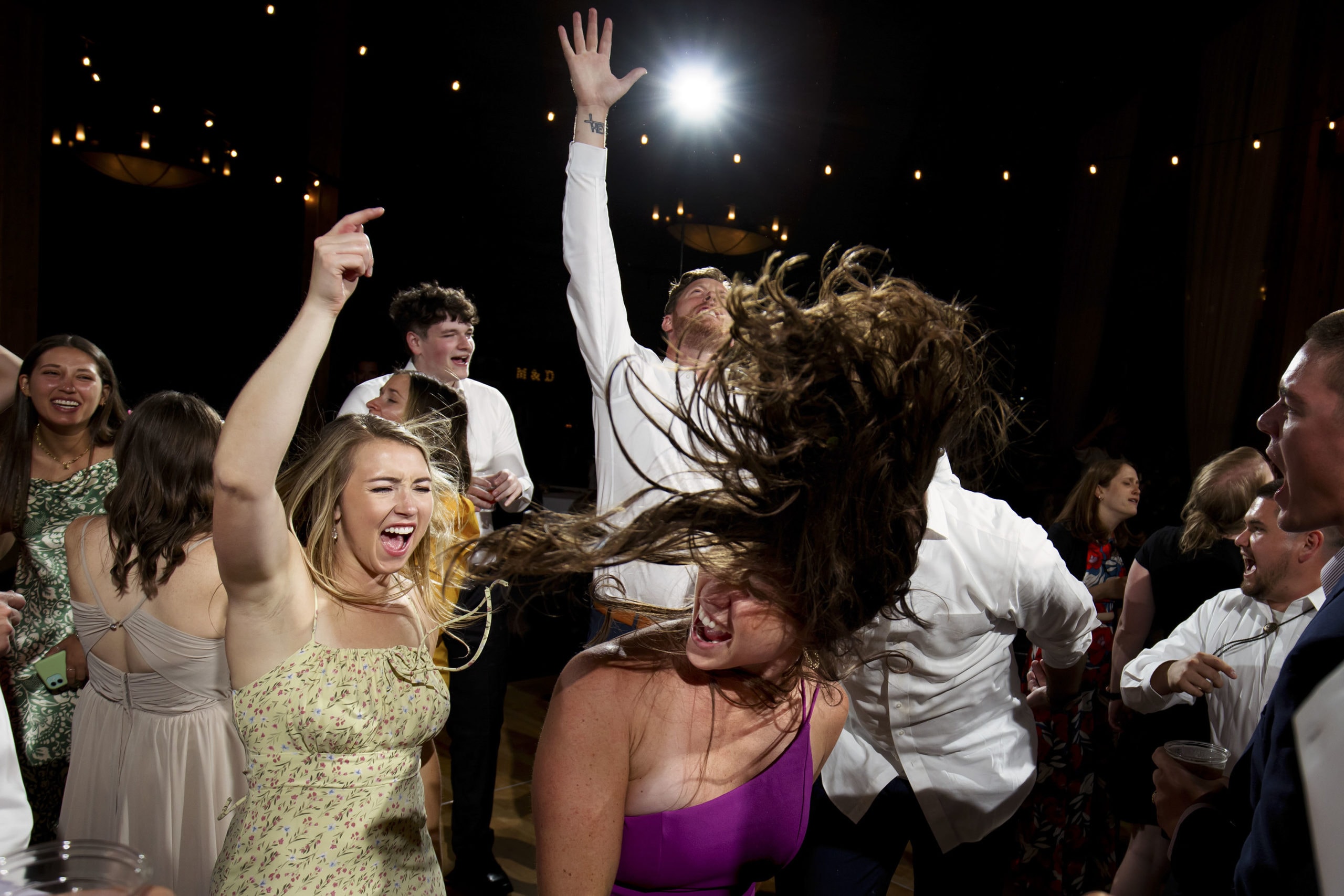 Guests dance during a wedding reception in the Grand Hall at Copper Station