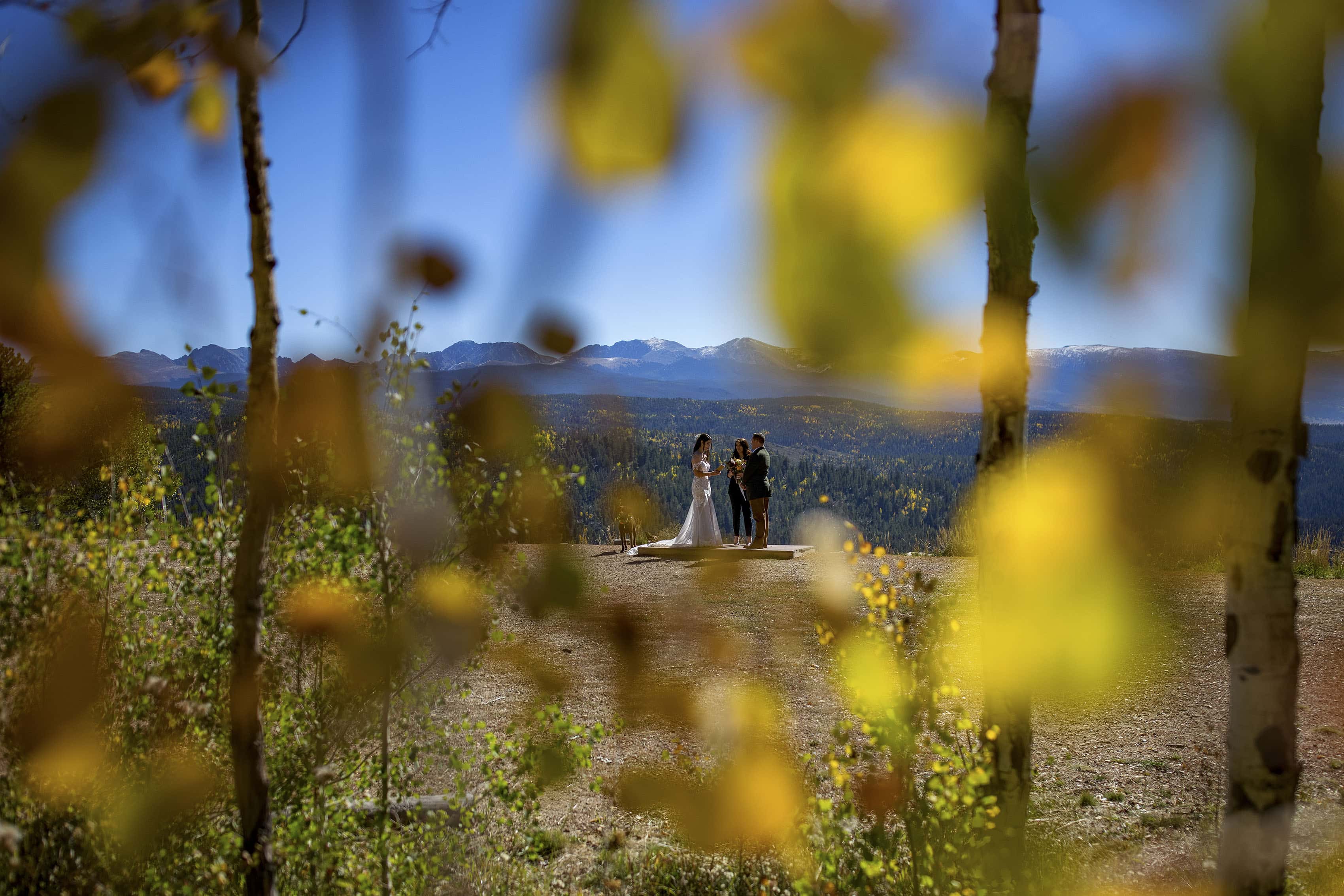 The bride and groom read their vows during their fall colors elopement at Granby Ranch