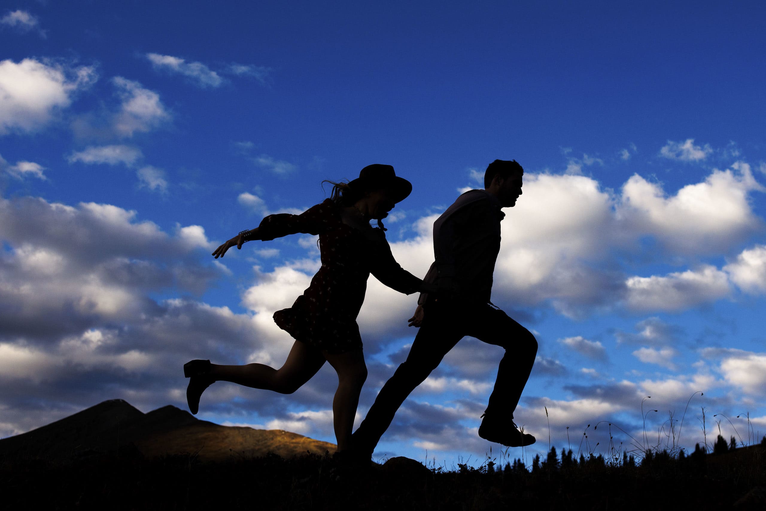 A couple is silhouetted as they run on Boreas Pass