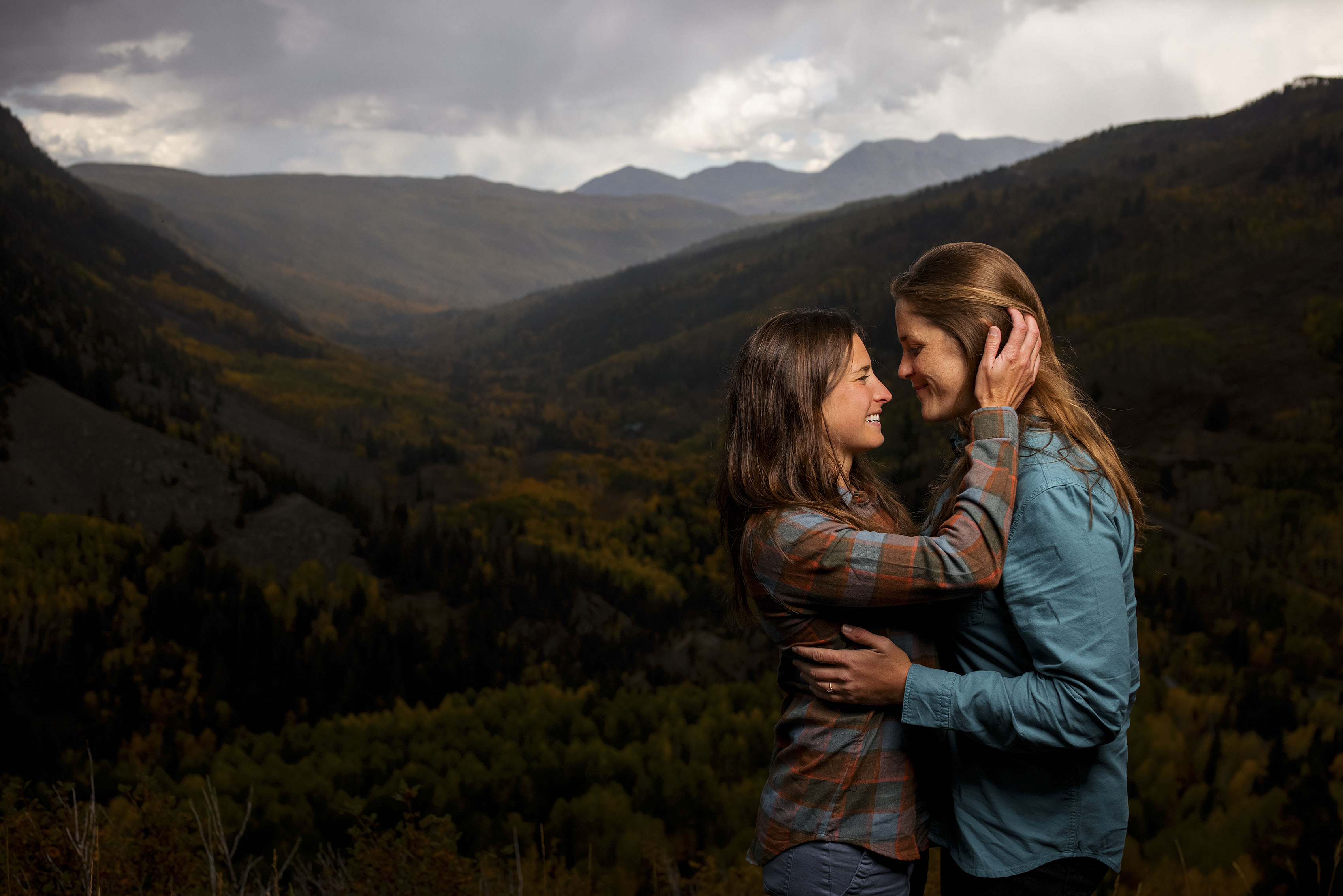 Two women embrace in Telluride during their fall engagement photos