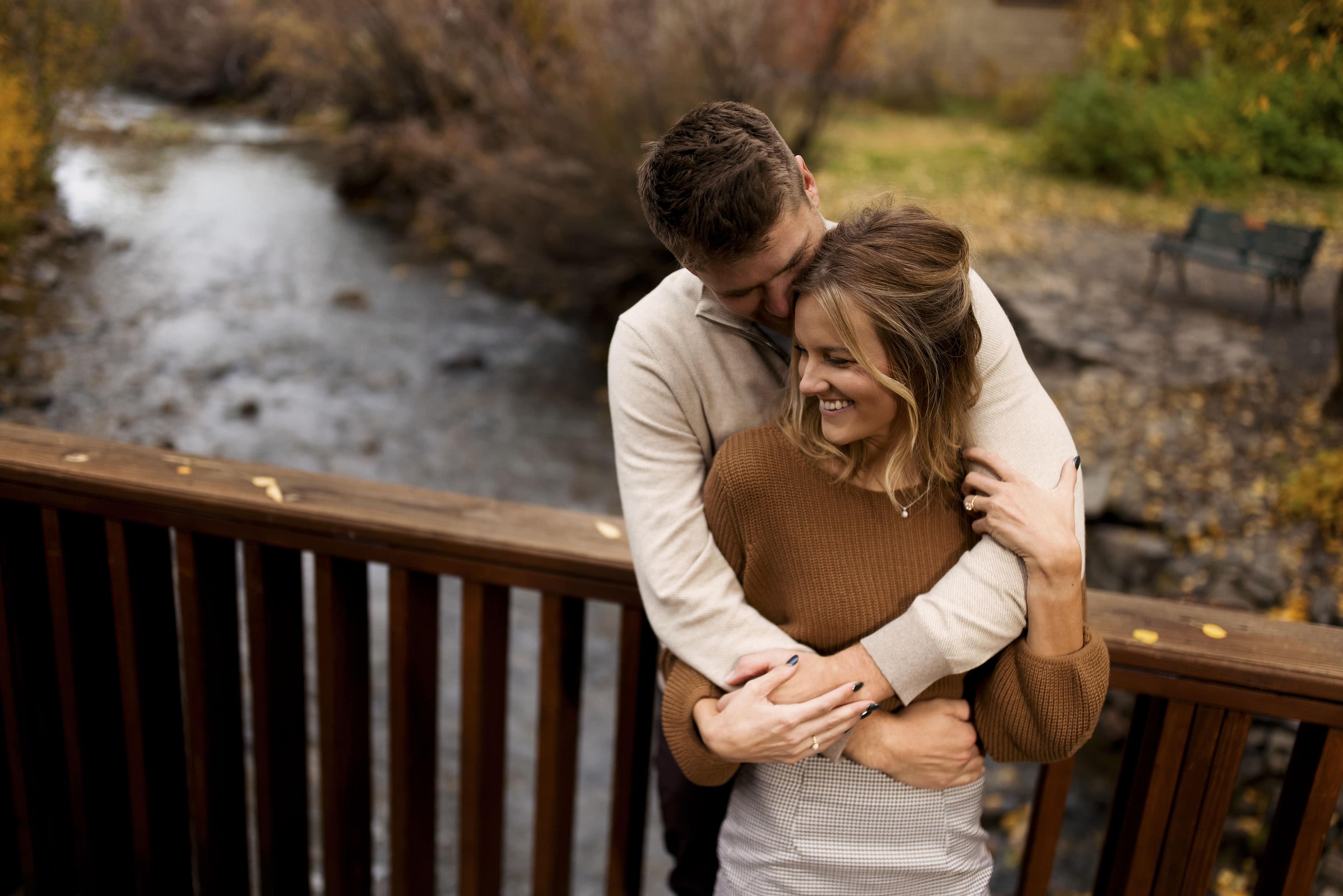 Willy and Kelly hug on a bridge over Coal Creek in Crested Butte