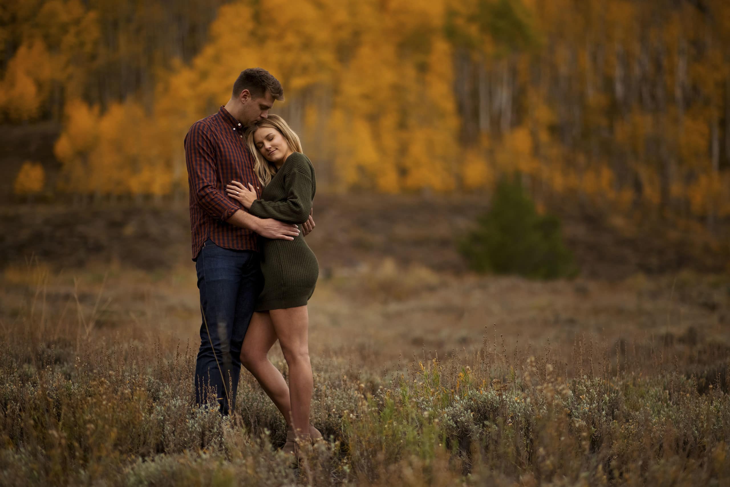 Willy and Kelly hug near an aspen grove at Peanut Lake in Crested Butte