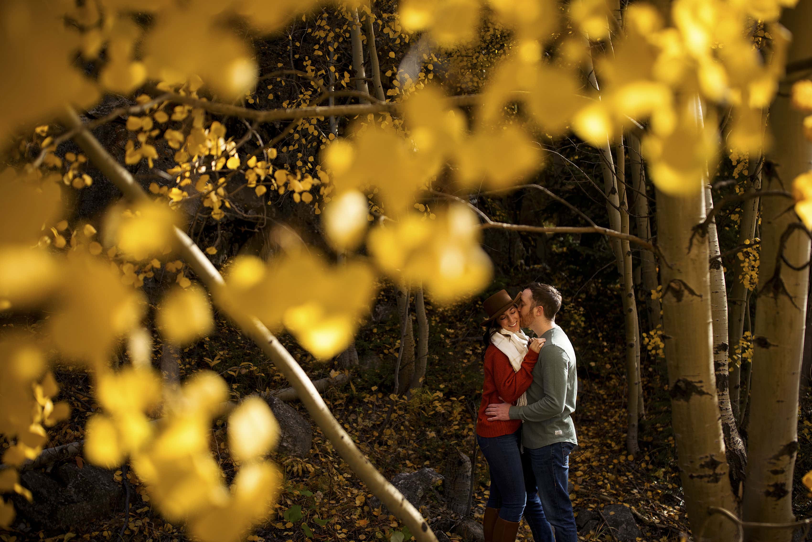 Gavin kisses Caitlin in an aspen grove