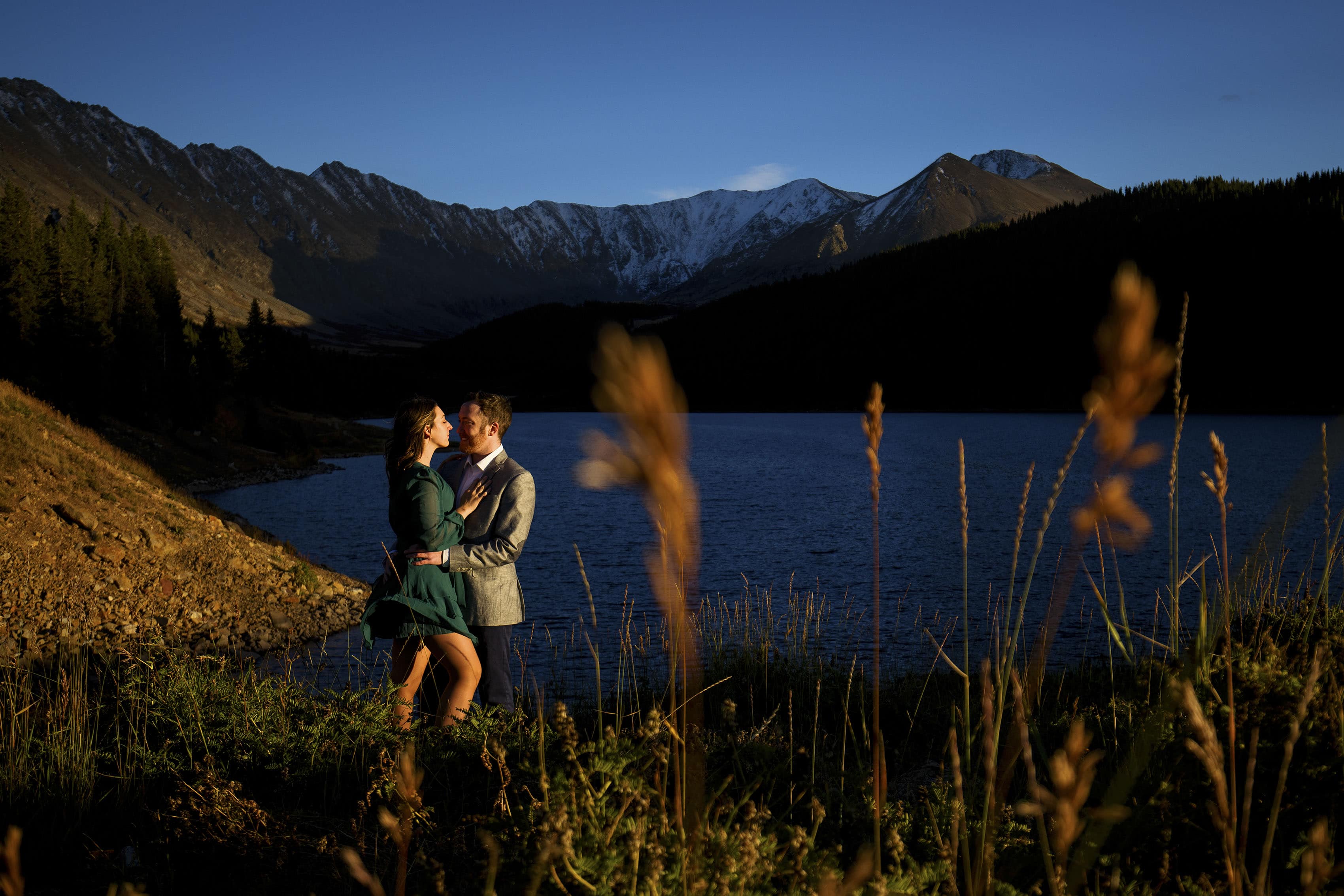 A couple poses at Clinton Gulch Dam Reservoir during their engagement session