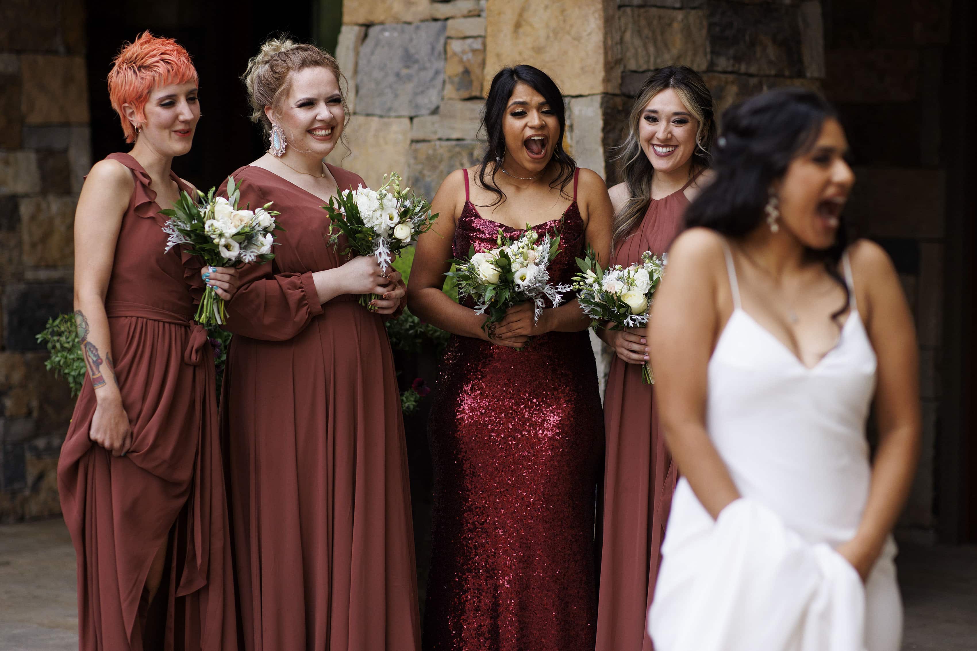 Bridesmaids react to seeing the bride in her gown