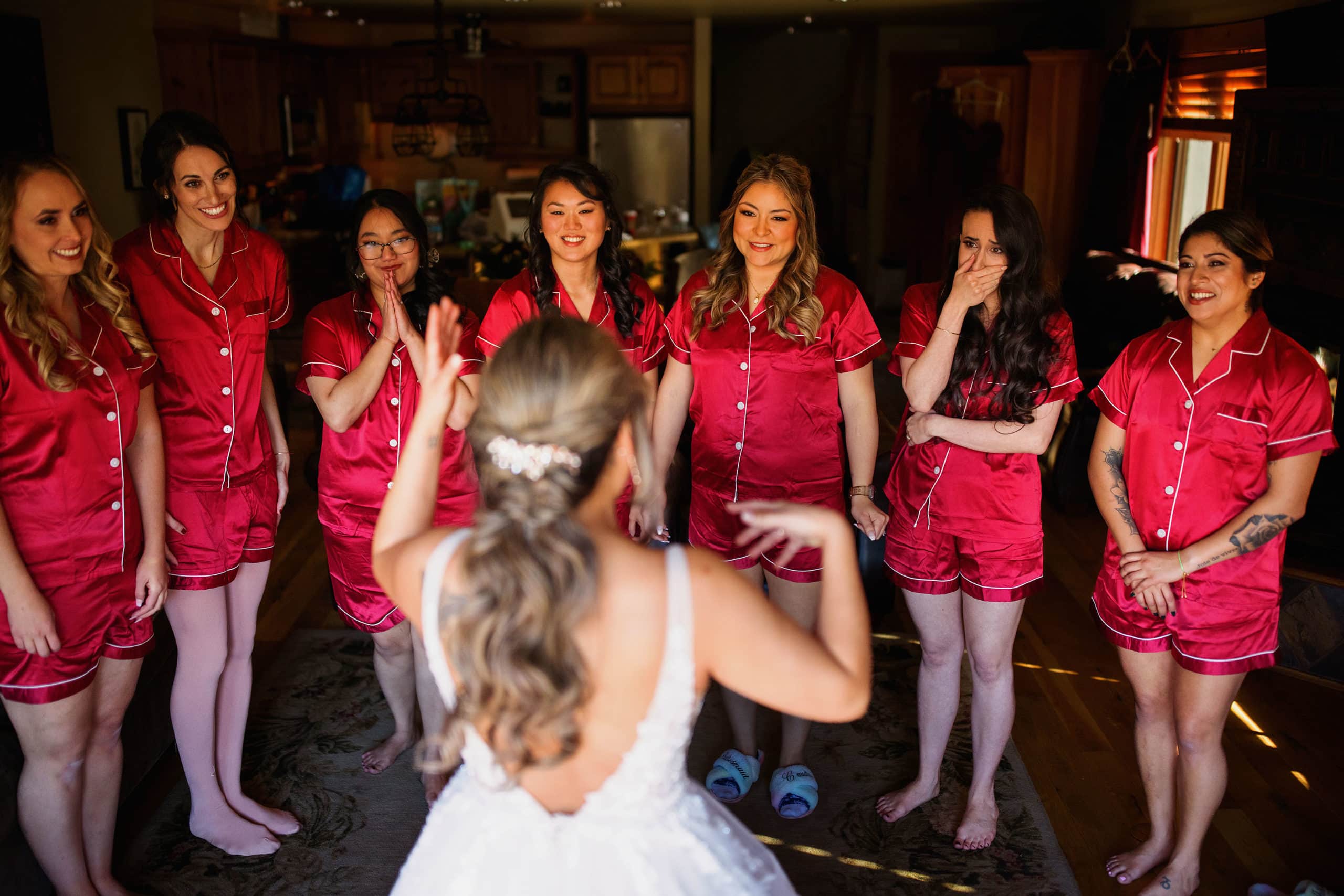Bridesmaids react to seeing the bride during her wedding day