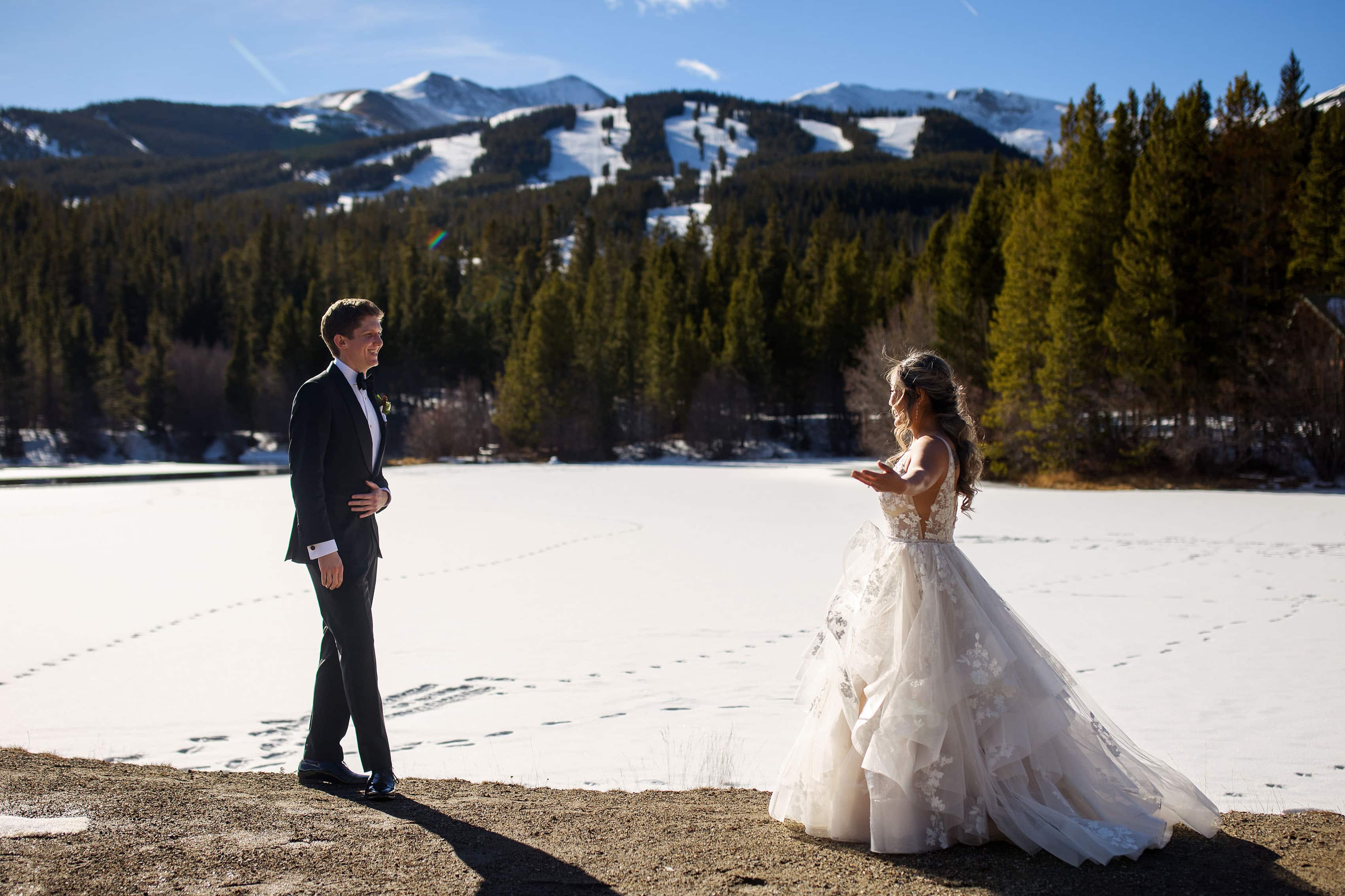 Chris and Julia react during their first look at Sawmill Reservoir on their wedding day in Breckenridge