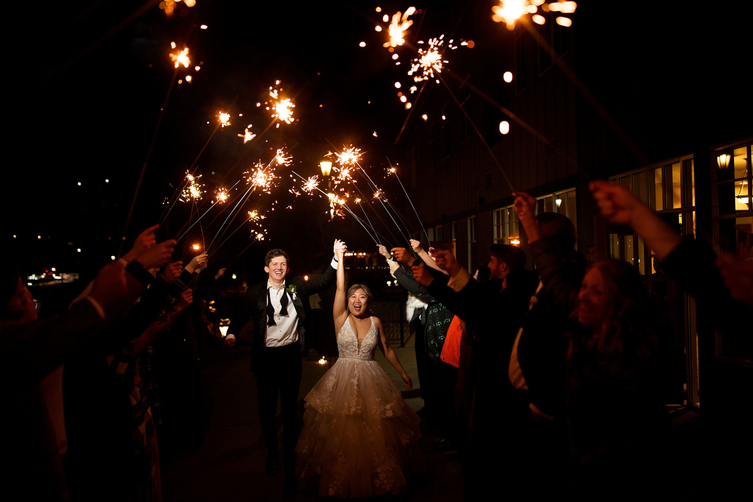 The newlyweds run through a sparkler exit at Main Street Station during their winter Breckenridge wedding