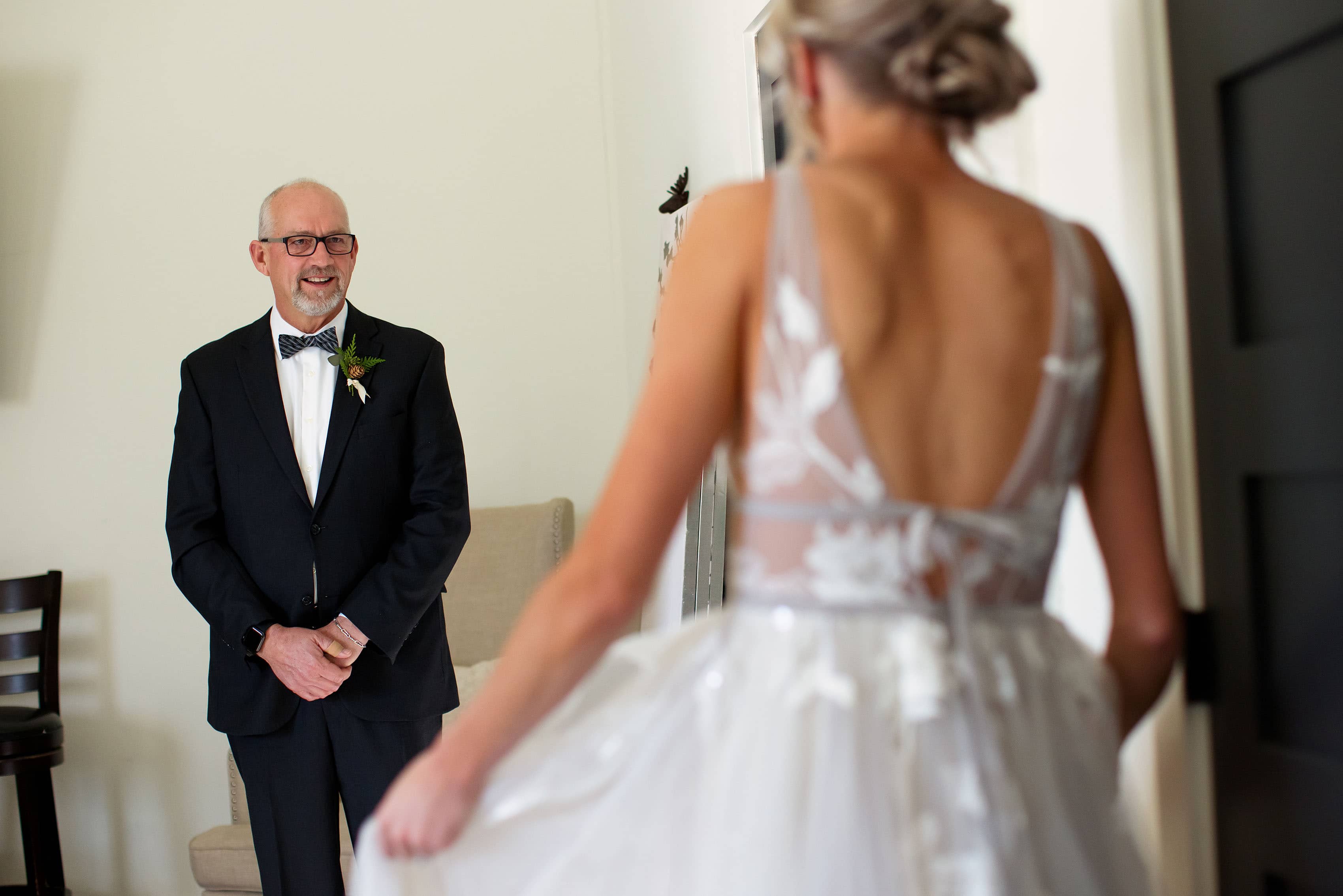The father of the bride sees her in her dress for the first time