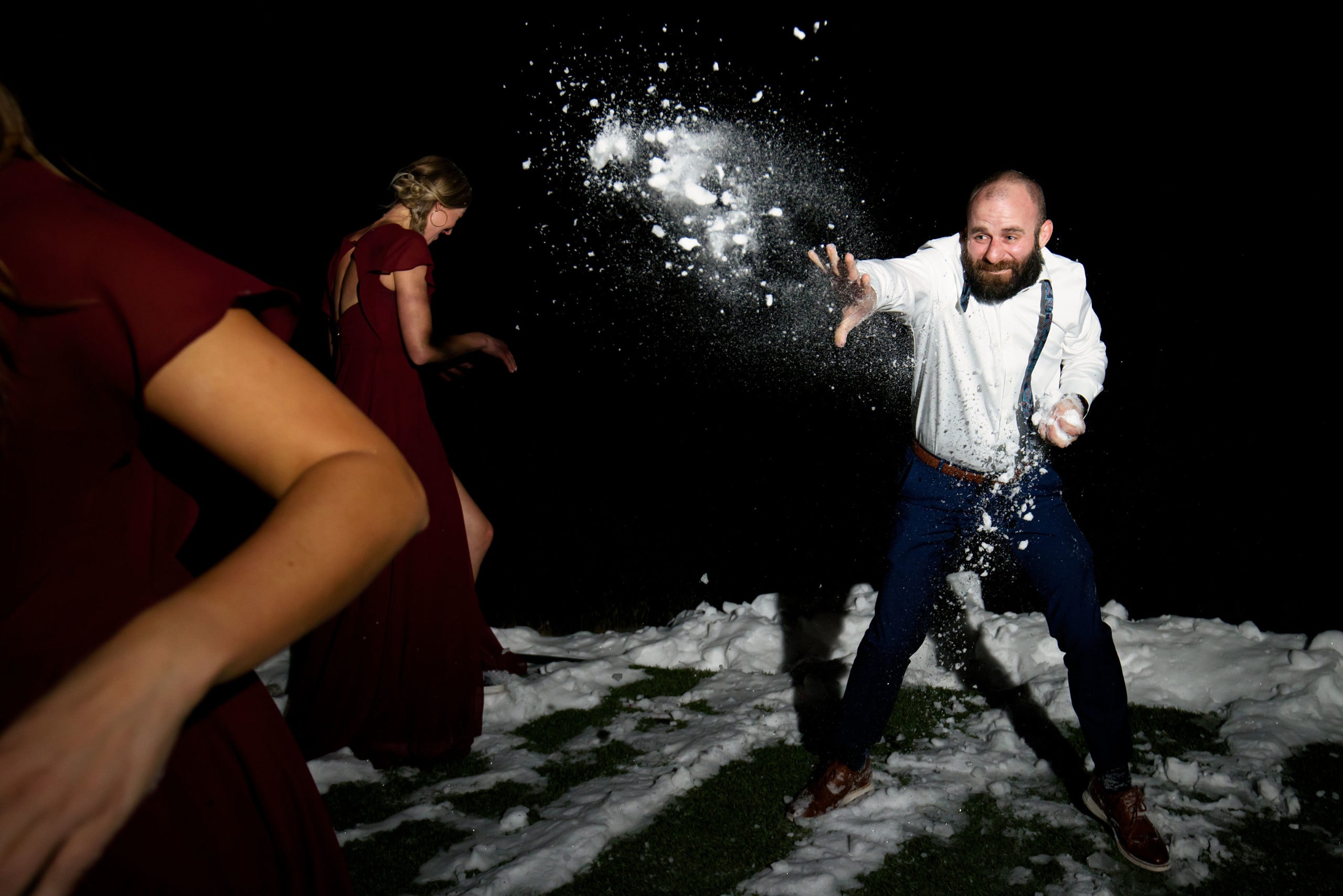 Wedding guests have a snowball fight at Woodlands during the wedding reception