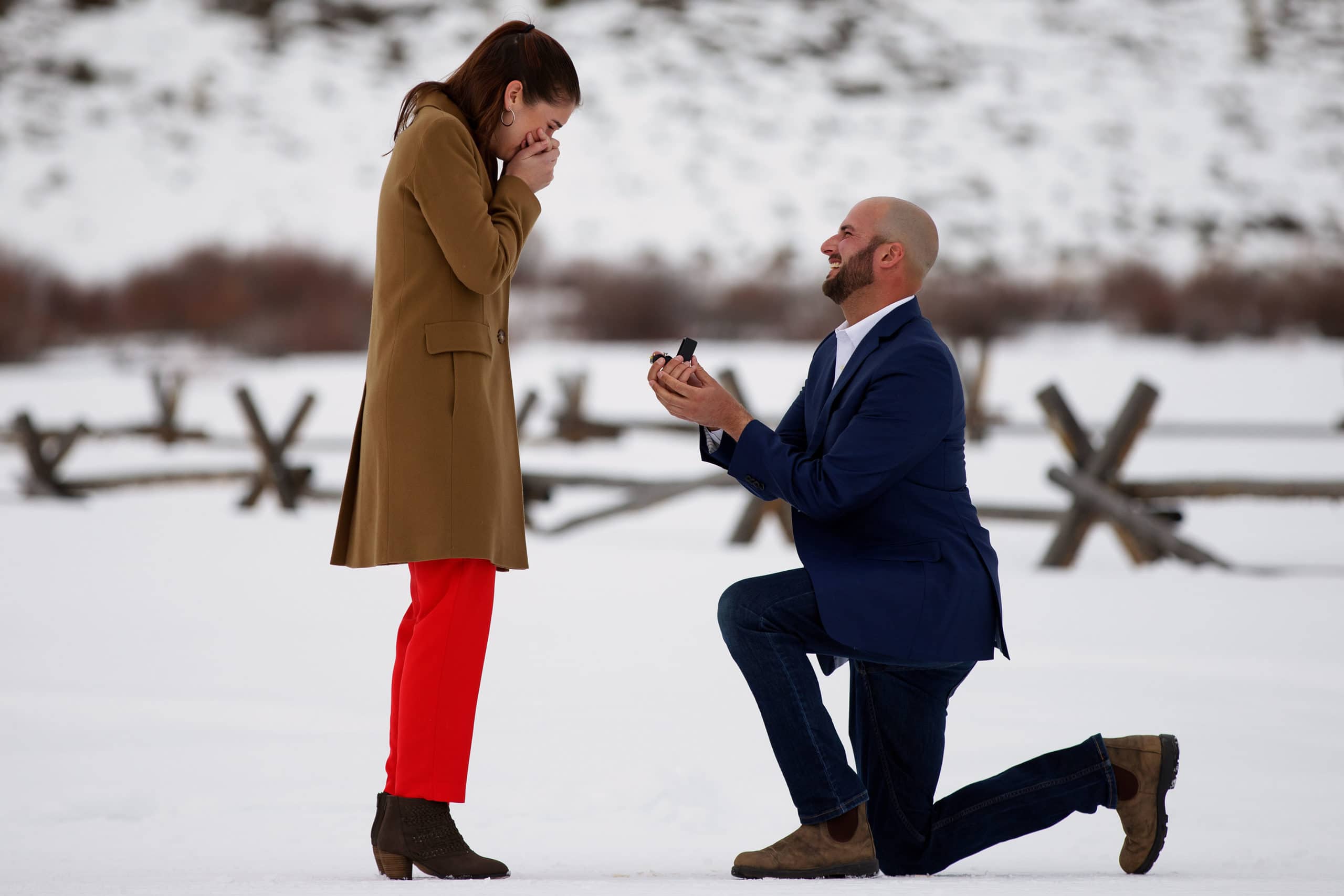 Sarah reacts as Michael proposes during the winter at Devil’s Thumb Ranch in Tabernash, Colorado