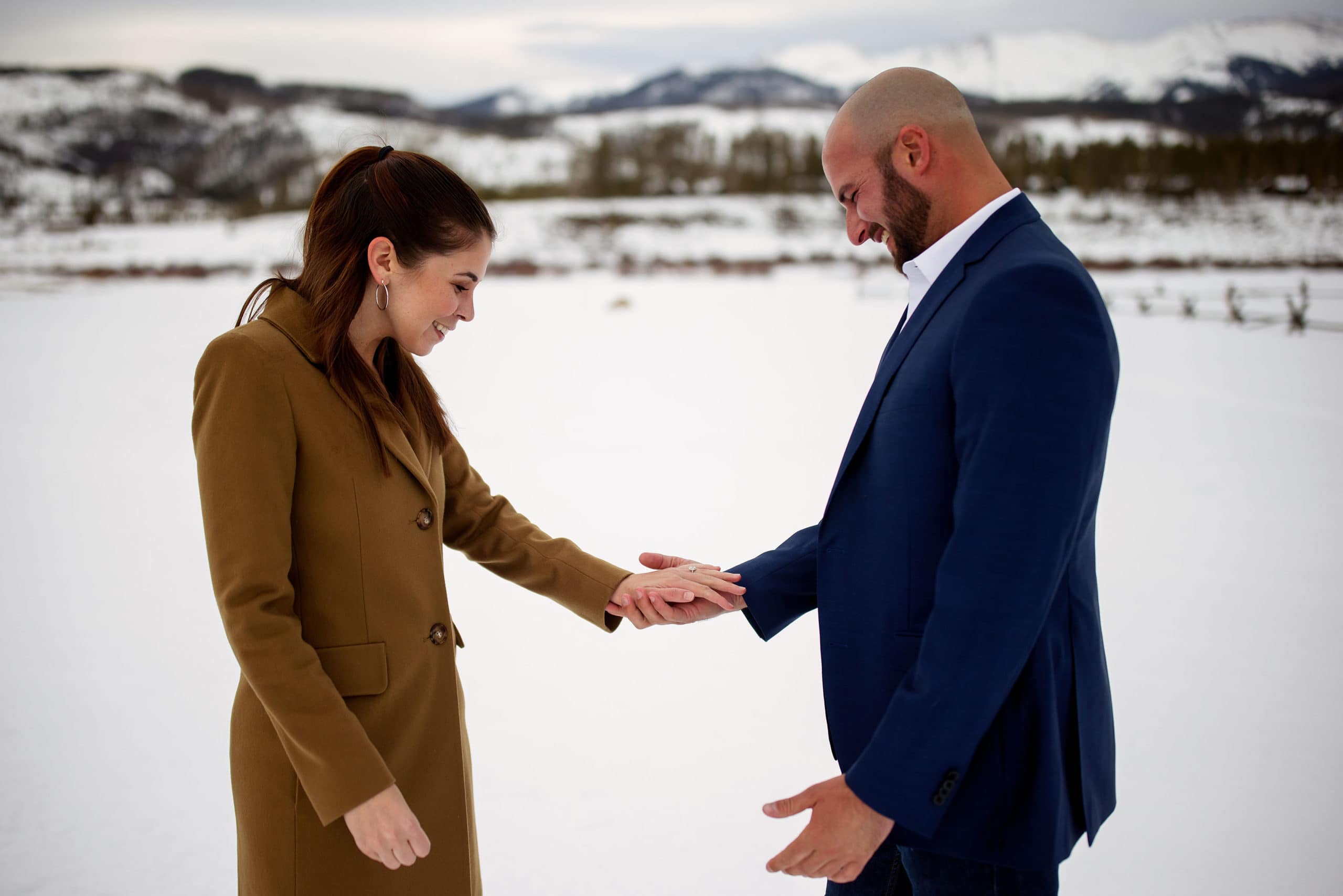 Sarah and Michael admire the engagement ring after their snowy proposal