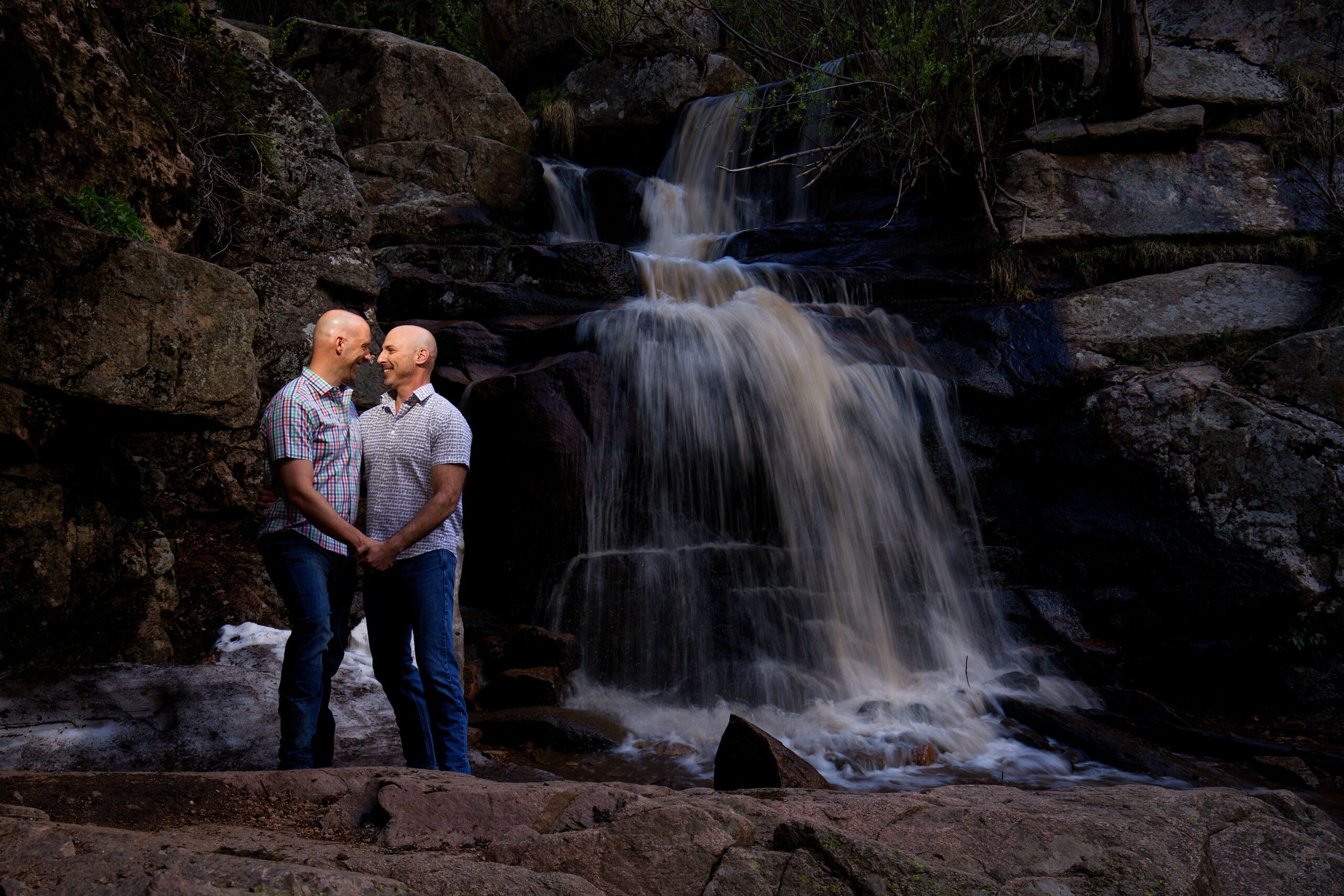 Josh and Todd pose near Maxwell Falls in Evergreen during their engagement