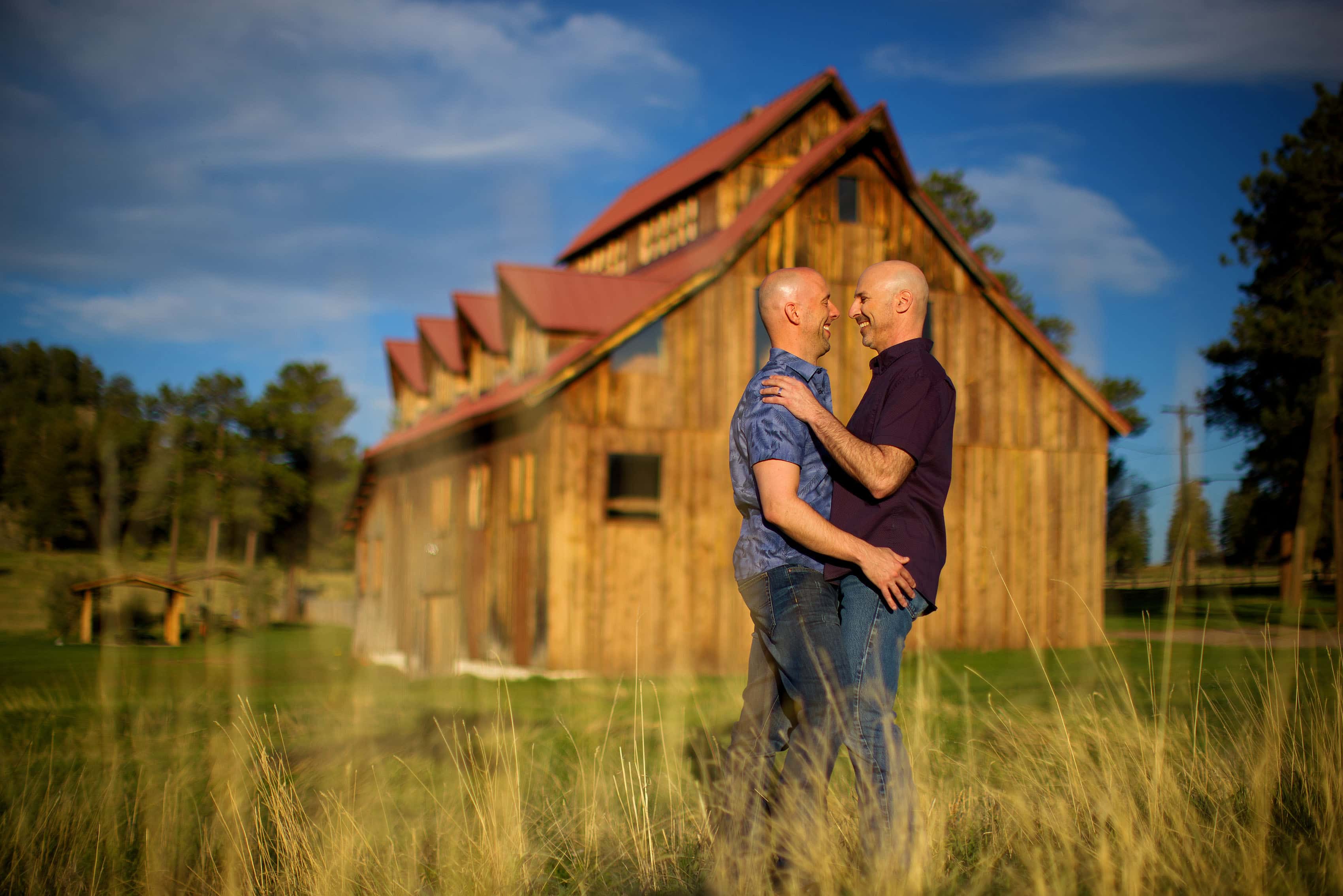 Josh and Todd share a moment near the Alderfer Three Sisters barn site during their Evergreen engagement session