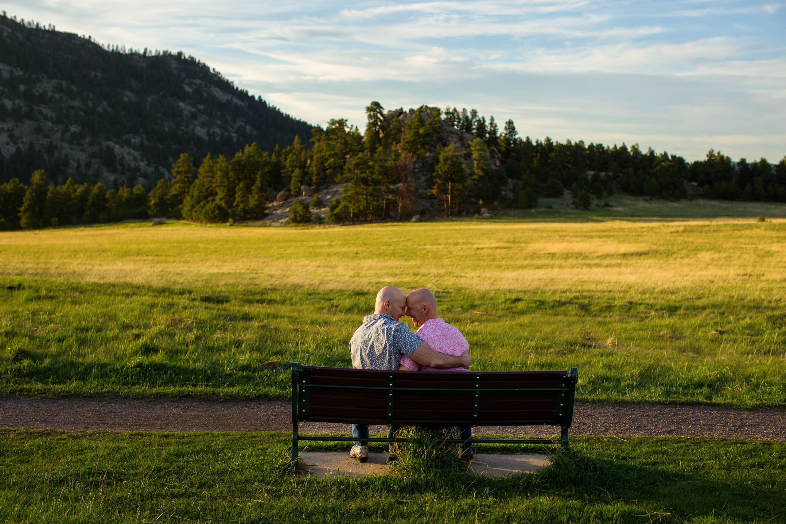Two guys share a moment together on a bench at Alderfer Three Sisters park in Evergreen
