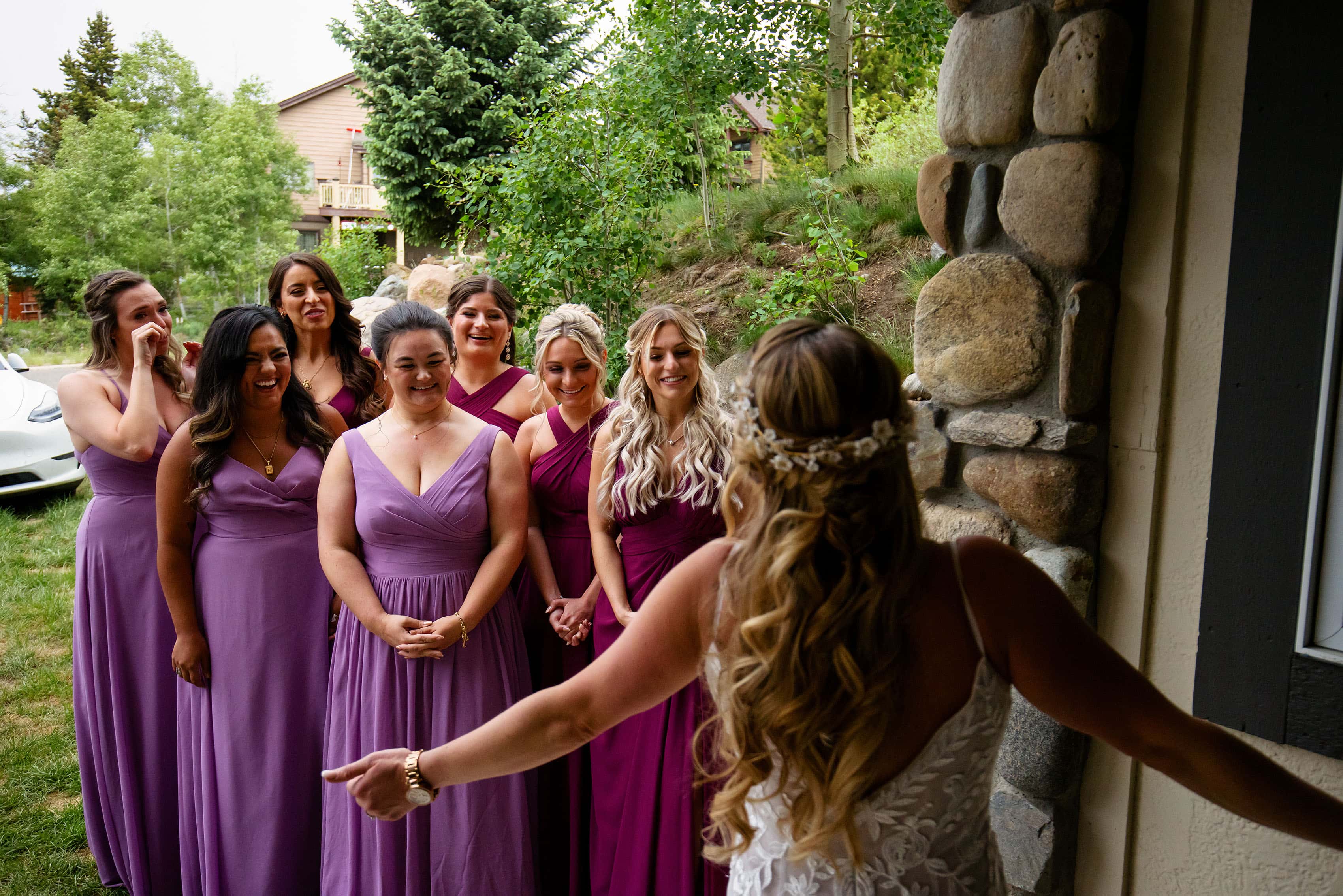 Bridesmaids react to seeing the bride in her dress for the first time