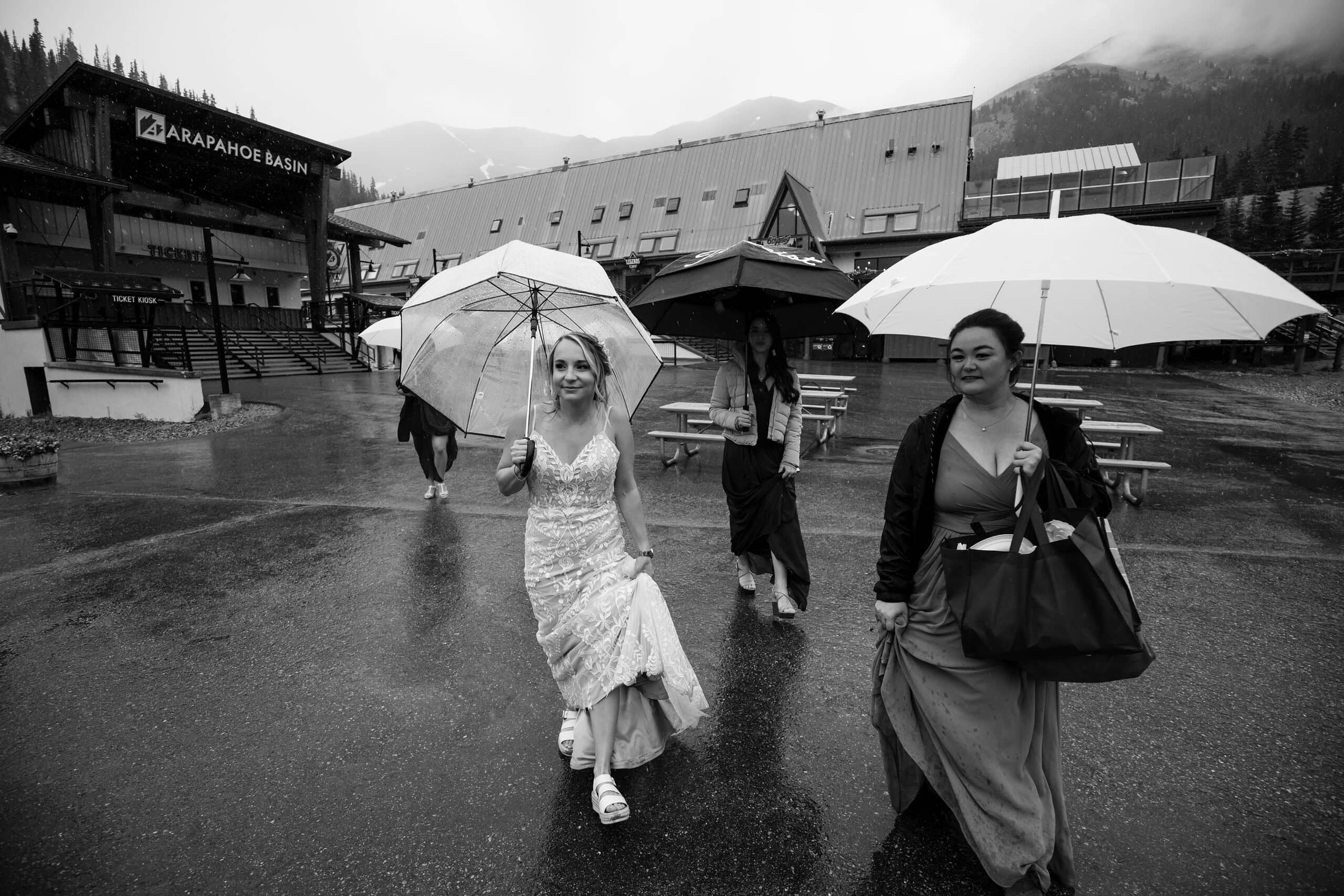 Diana walks in the rain with her bridesmaids at Arapahoe basin