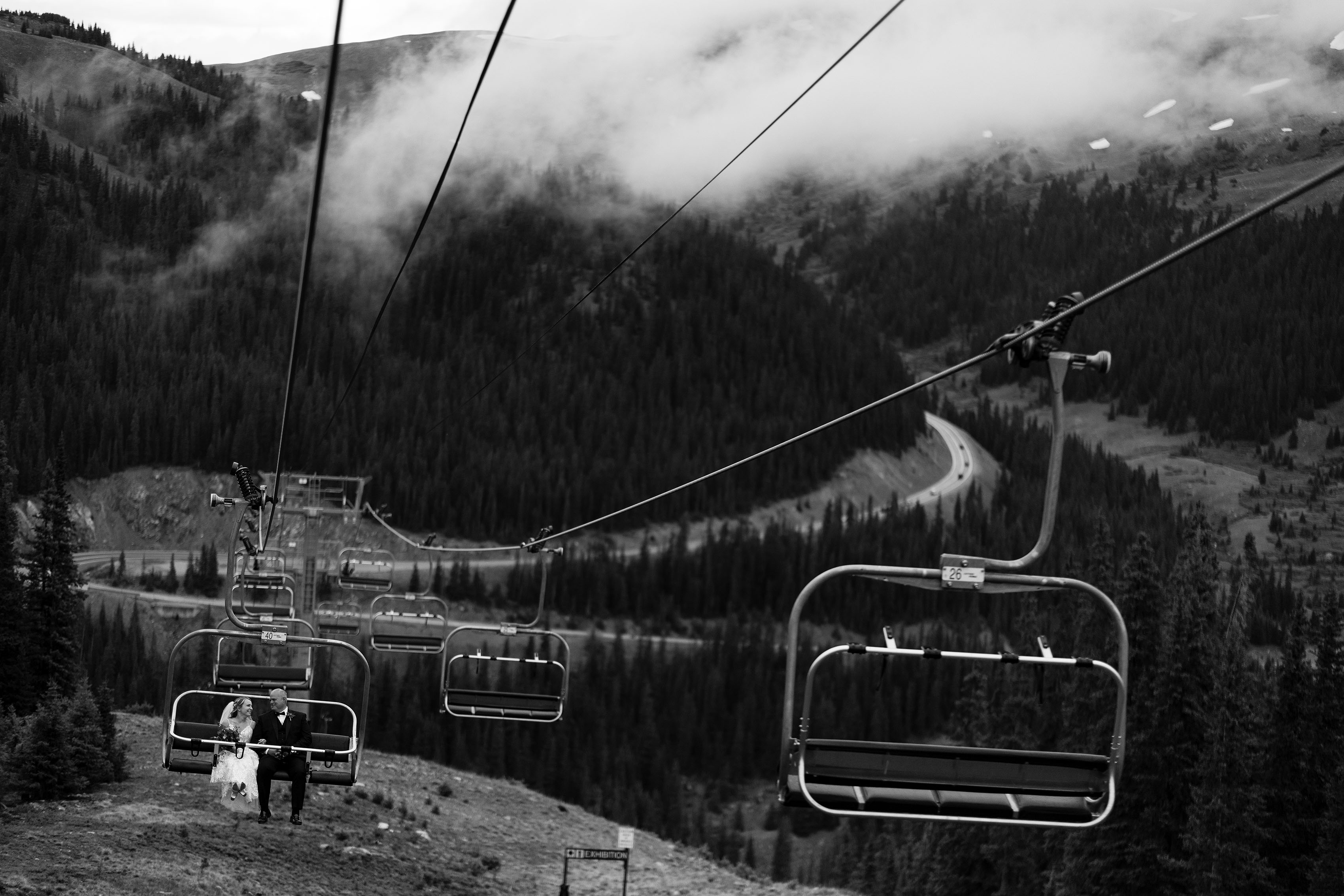 The bride rides the chairlift to the ceremony