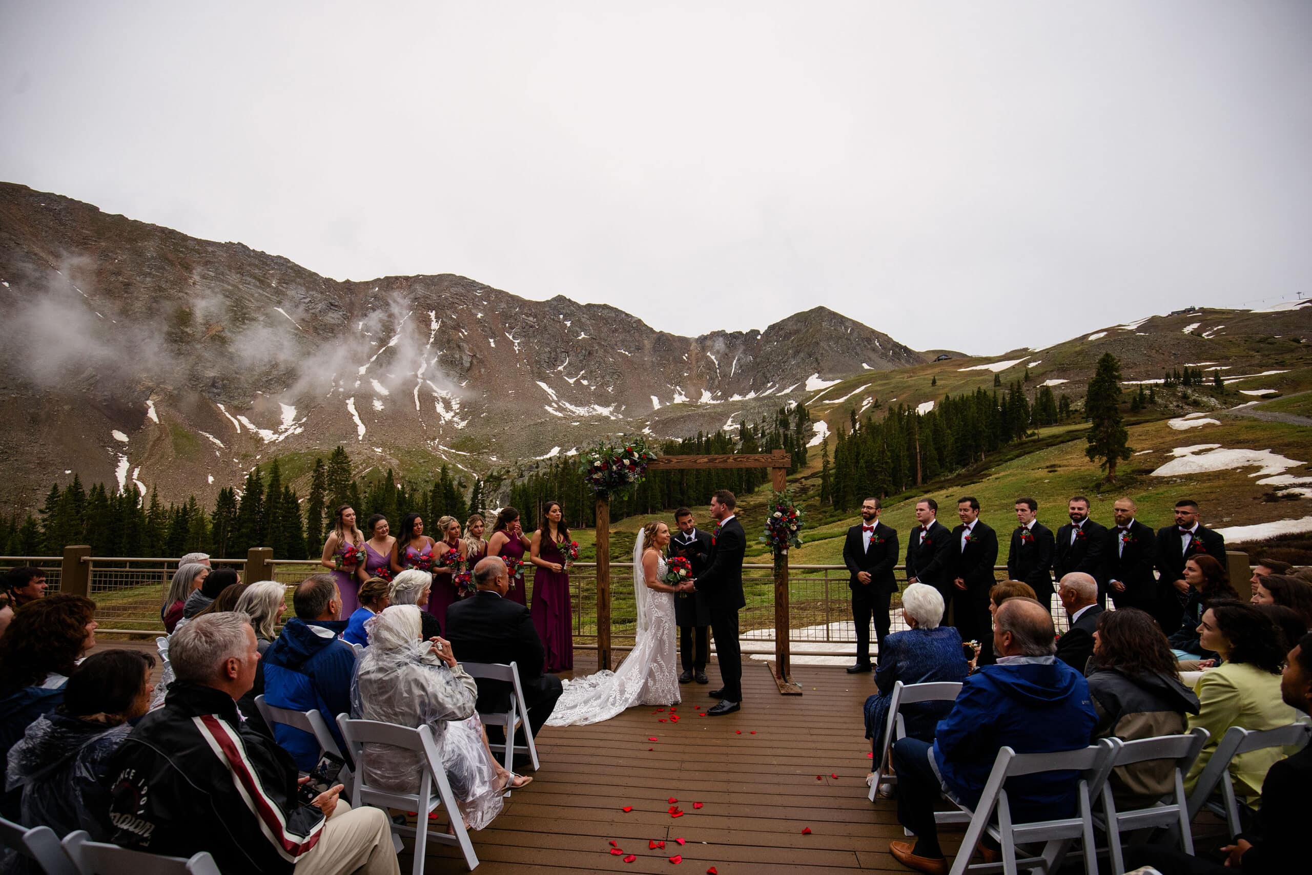 Overcast summer wedding ceremony at Arapahoe Basin’s Black Mountain Lodge