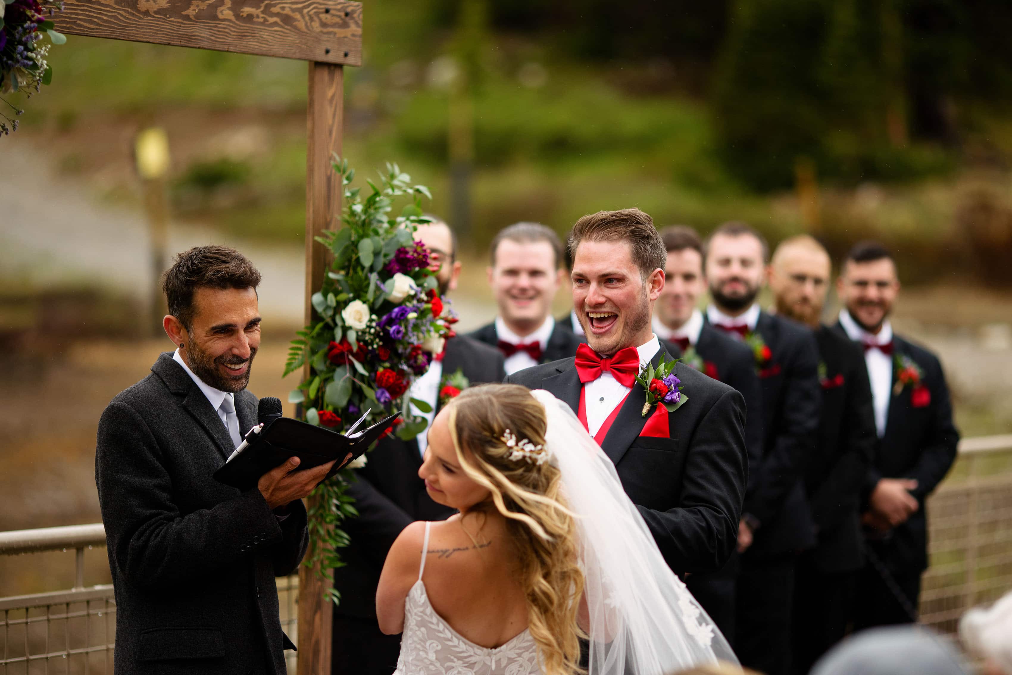 The groom laughs during the wedding ceremony