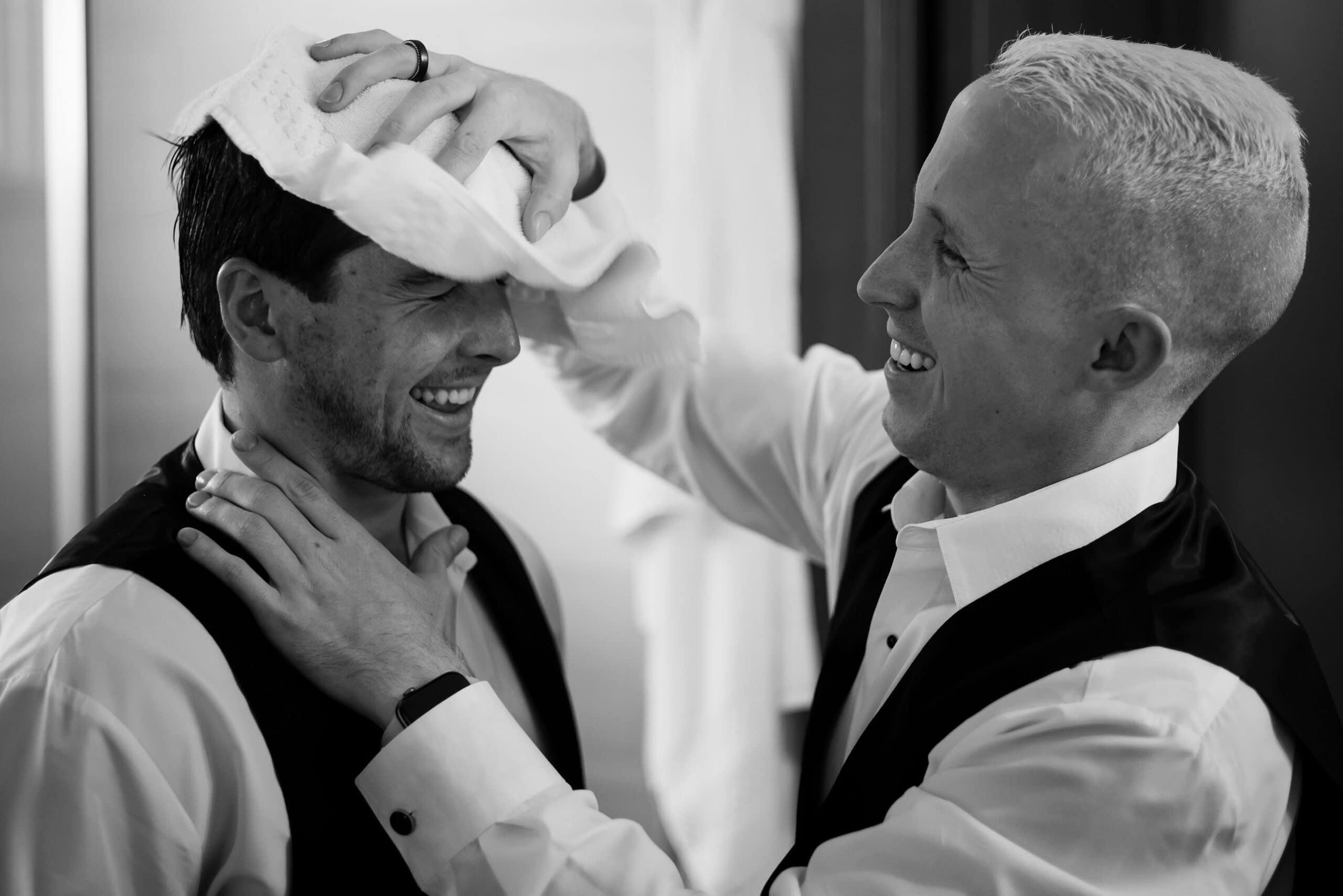 The groom gets help with his hair on the wedding day