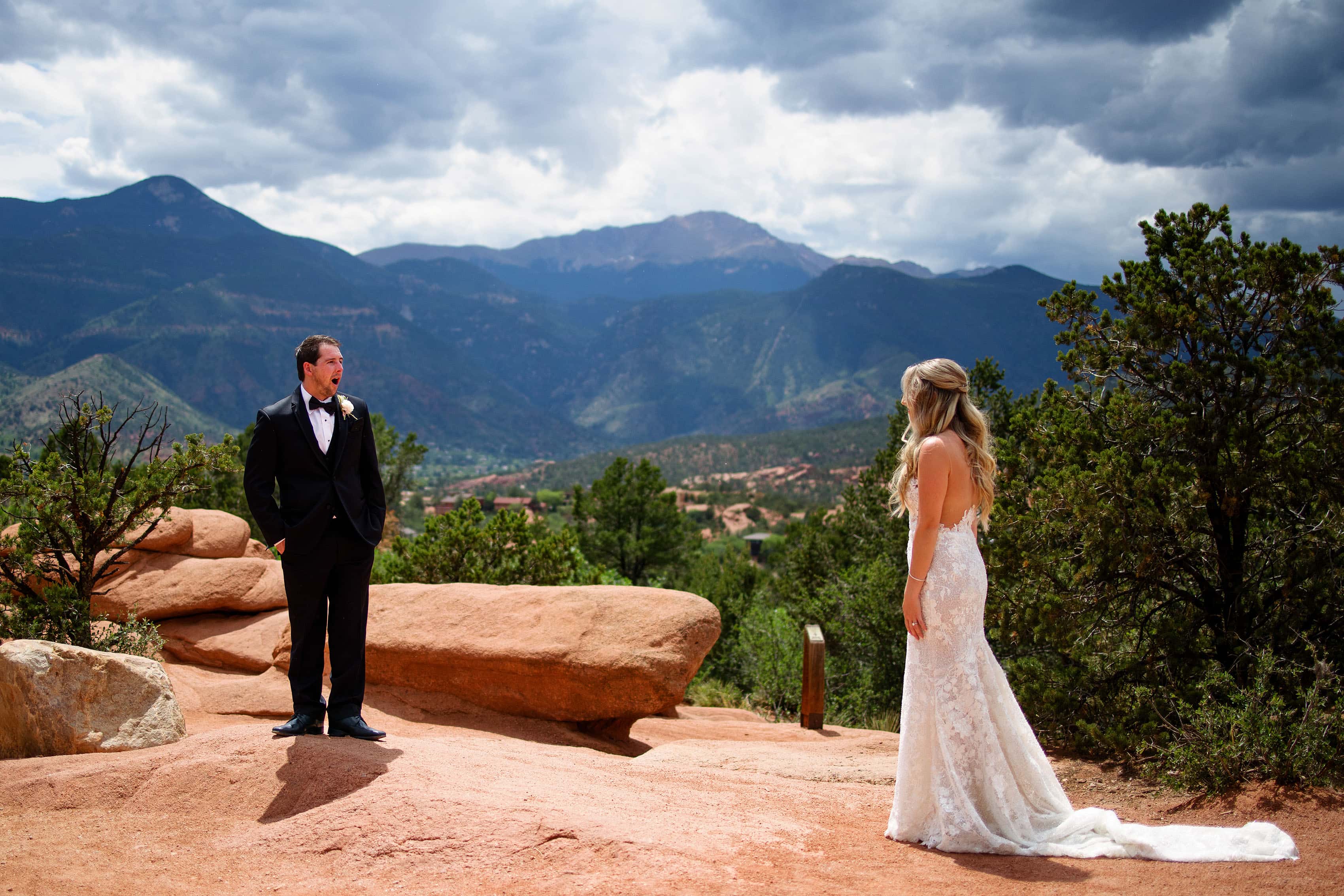 The groom reacts to seeing the bride during their first look at Garden of the Gods