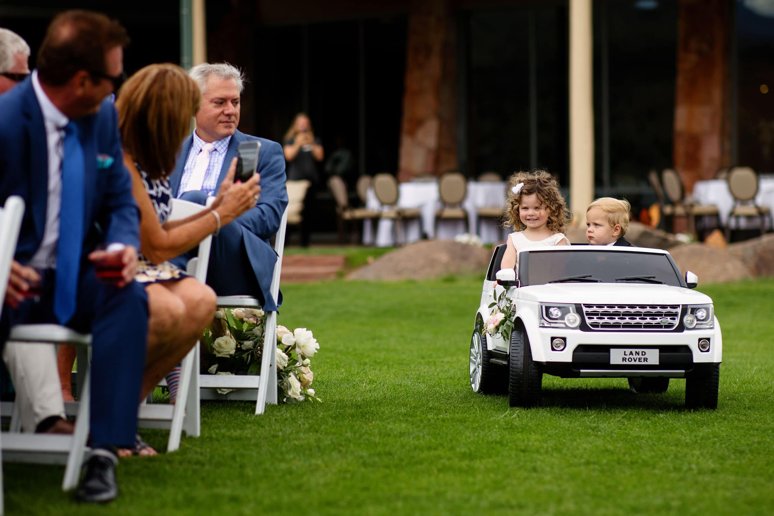 Kids drive down the ceremony aisle in a toy Range Rover at Garden of the Gods Resort