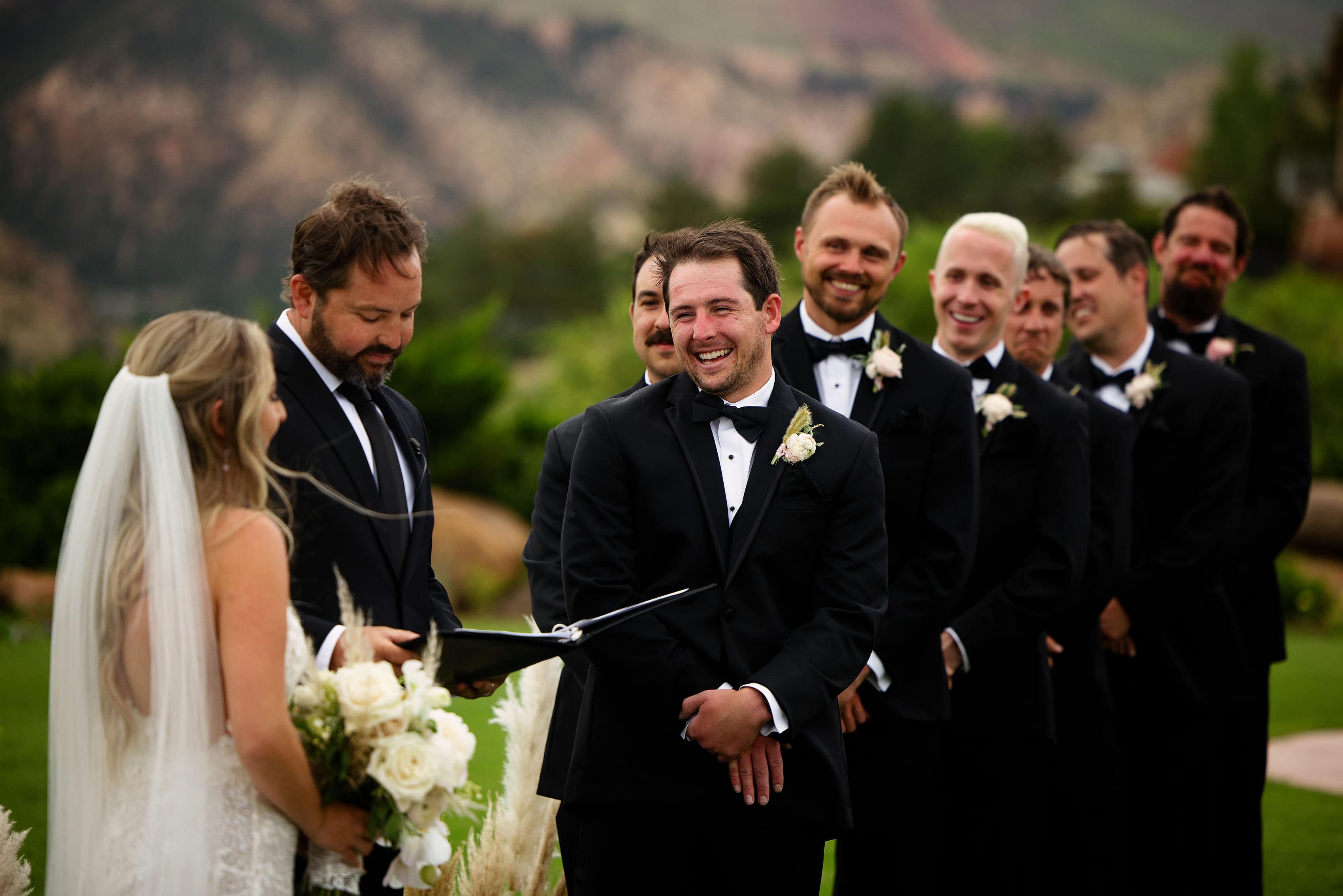 The groom laughs during the ceremony