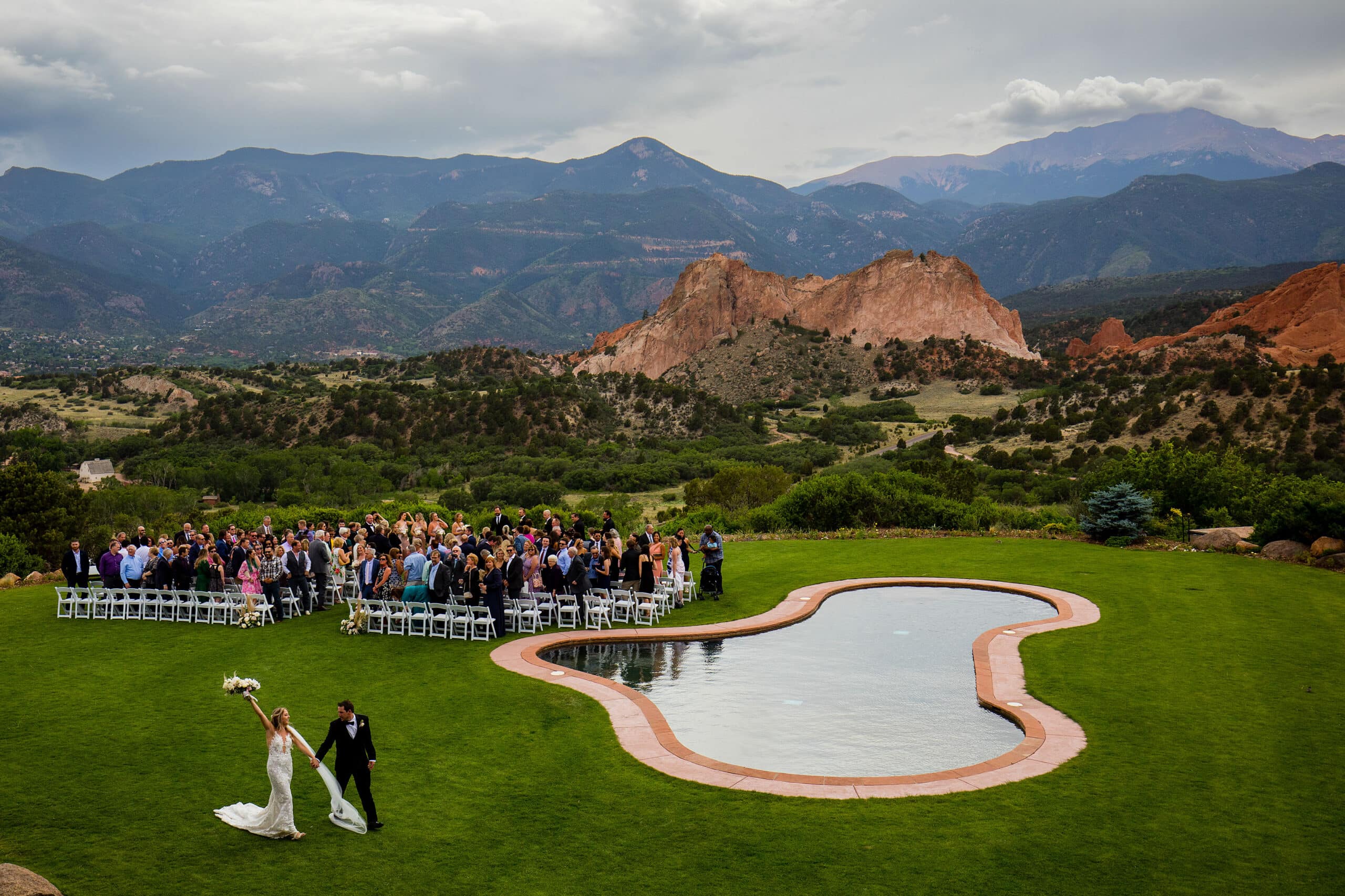 The bride and groom celebrate as they leave their wedding ceremony at Garden of the Gods Resort in Colorado Springs